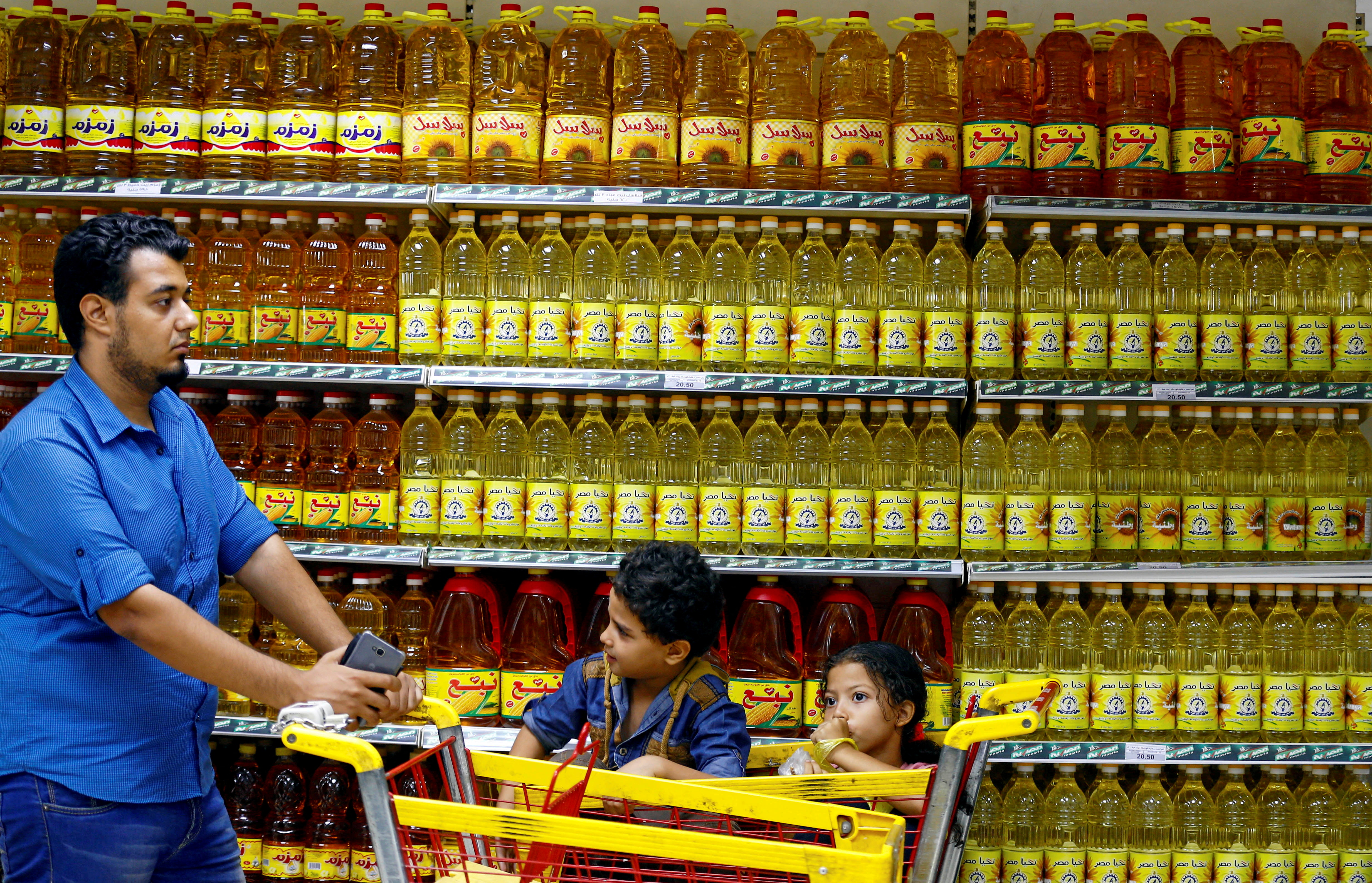 Shoppers are seen in an aisle with subsidised vegetable oils at a government outlet in Cairo