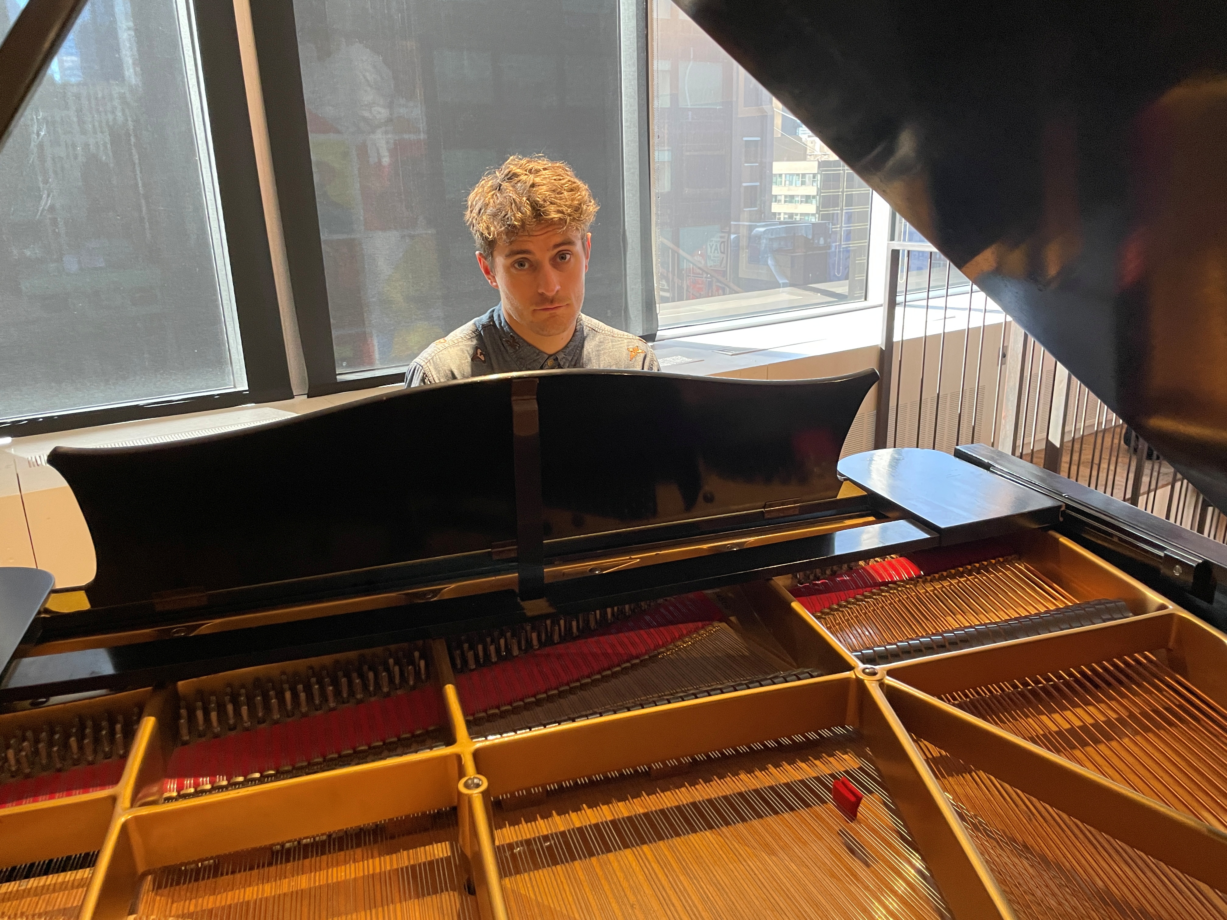 Jakub Jozef Orlinski, opera singer and breakdance performer, plays piano at the Warner Music offices in New York City, New York, U.S. December 3, 2021. REUTERS/Aleksandra Michalska
