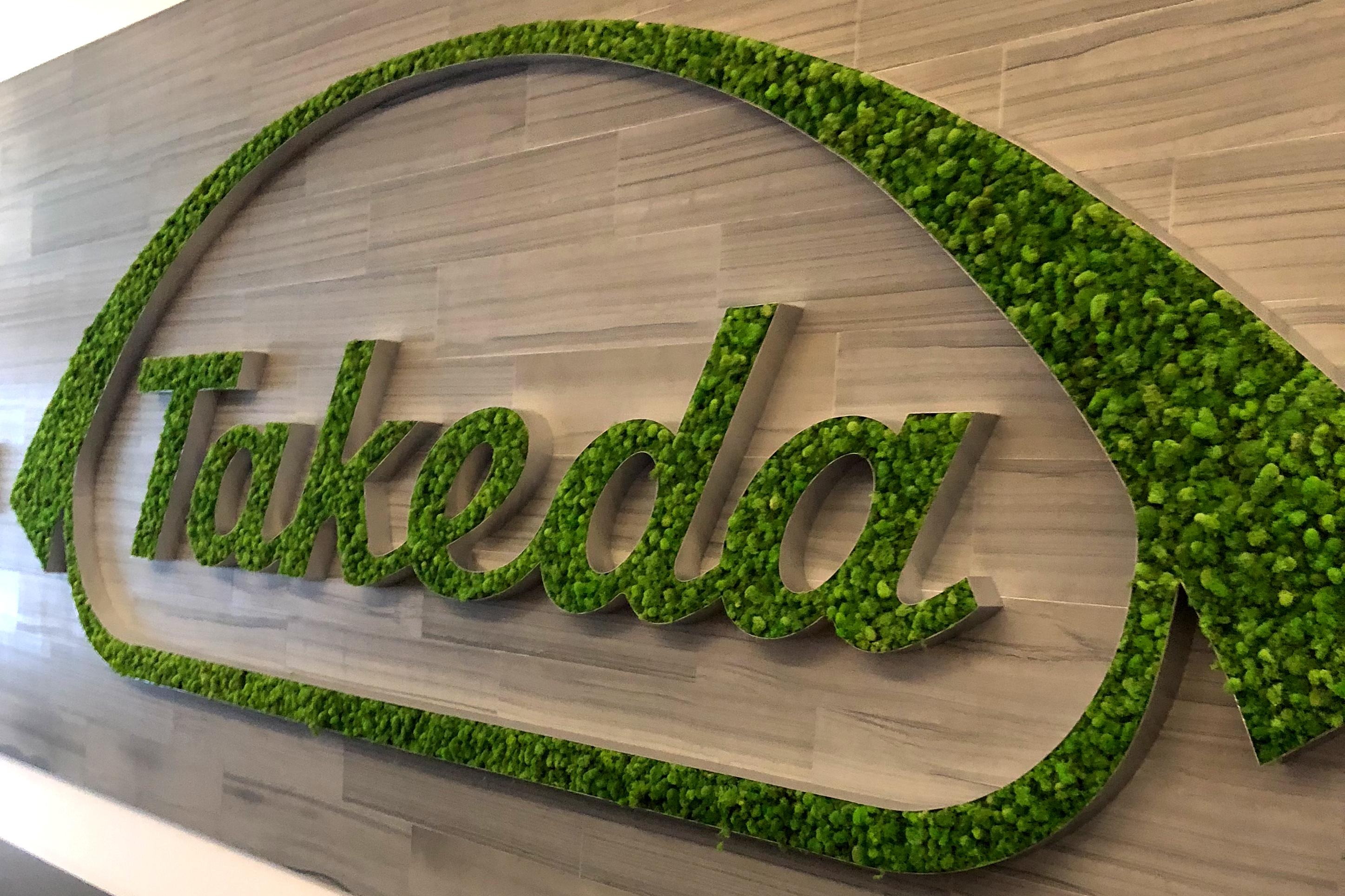 A Takeda logo is seen in its research hub in Cambridge