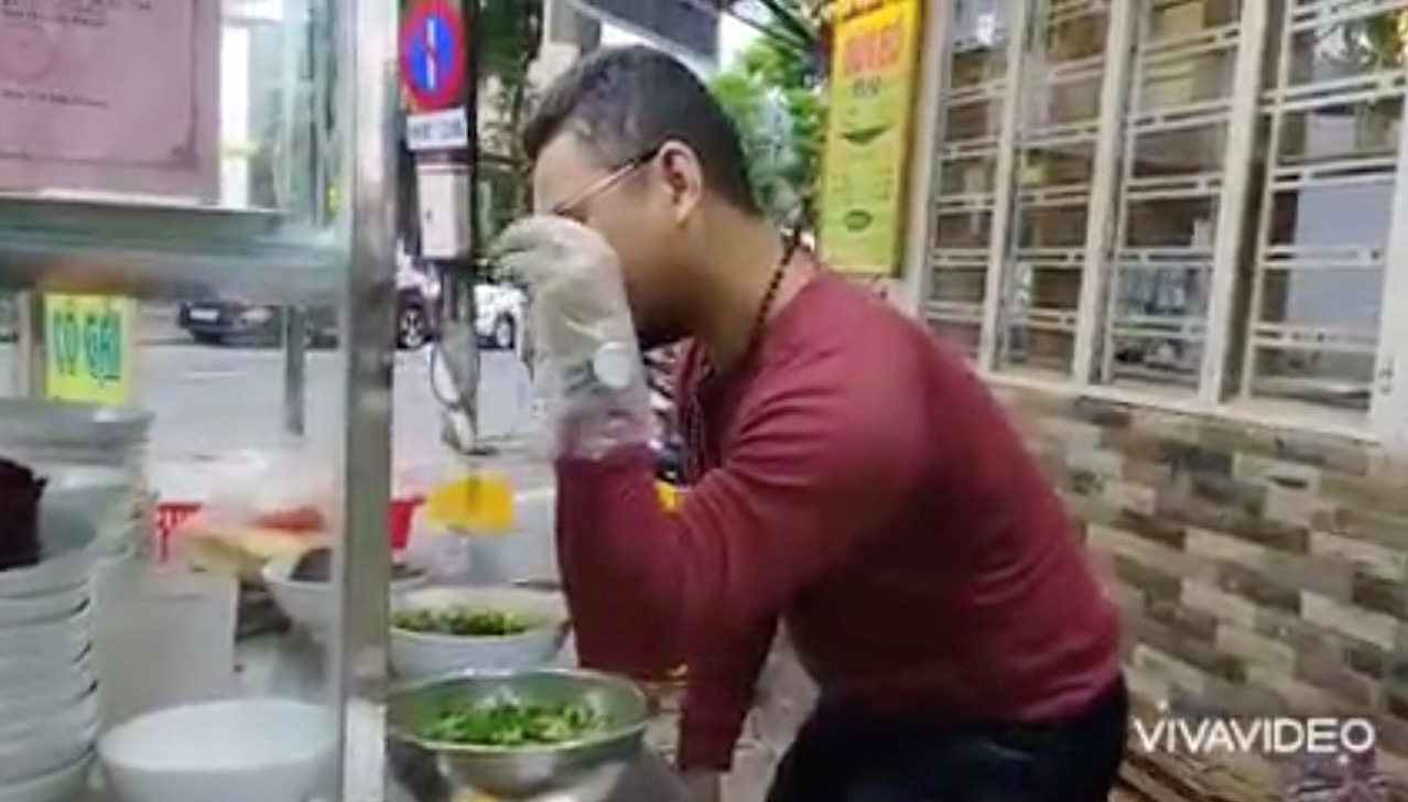 Bui Tuan Lam, 38, cooks at his beef noodle shop, in Danang, Vietnam, November 11, 2021, in this still image obtained from a social media video on November 17, 2021. Bui Tuan Lam/via REUTERS    