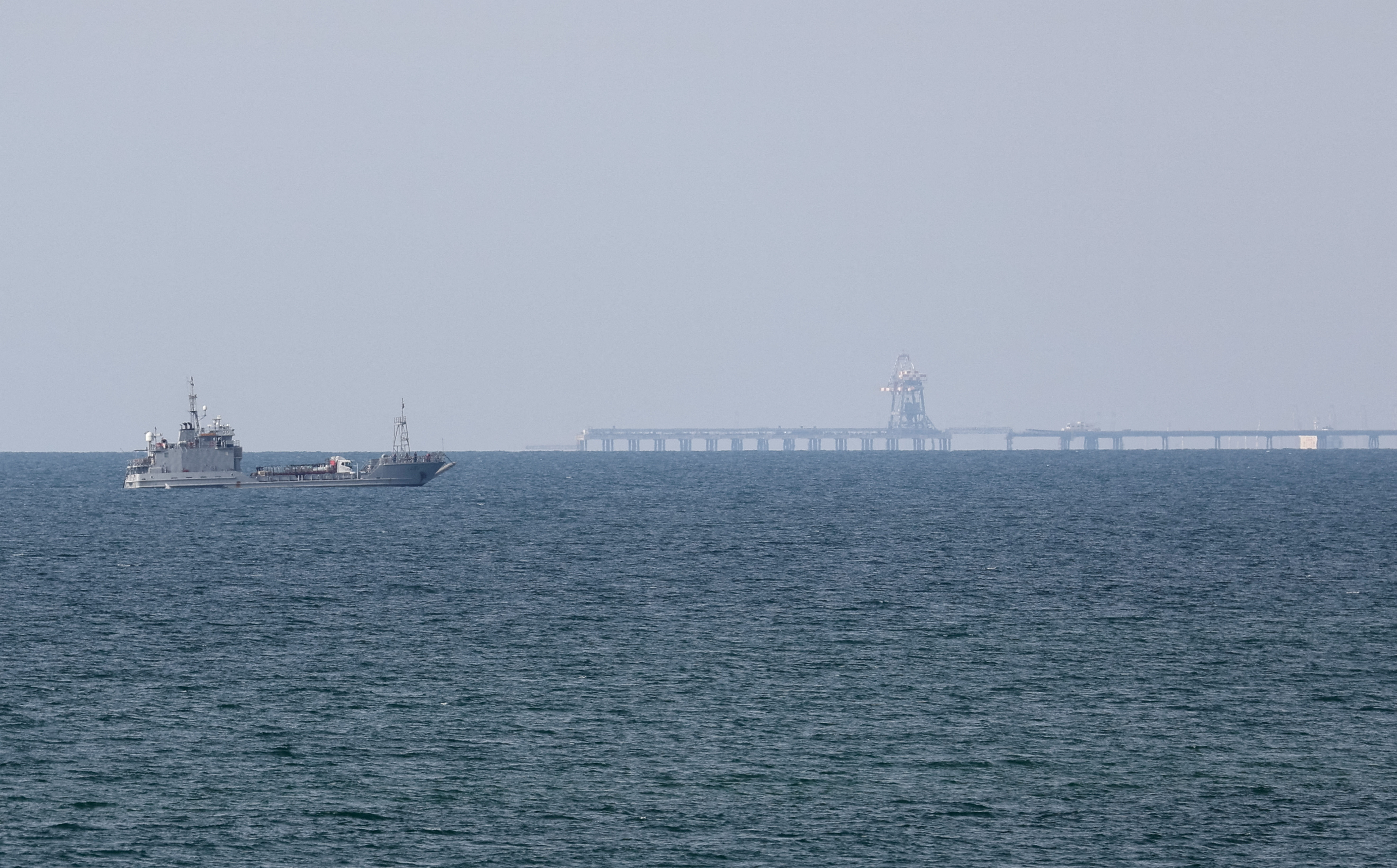 A ship loaded with aid sails near a U.S.-built pier, as seen from central Gaza Strip