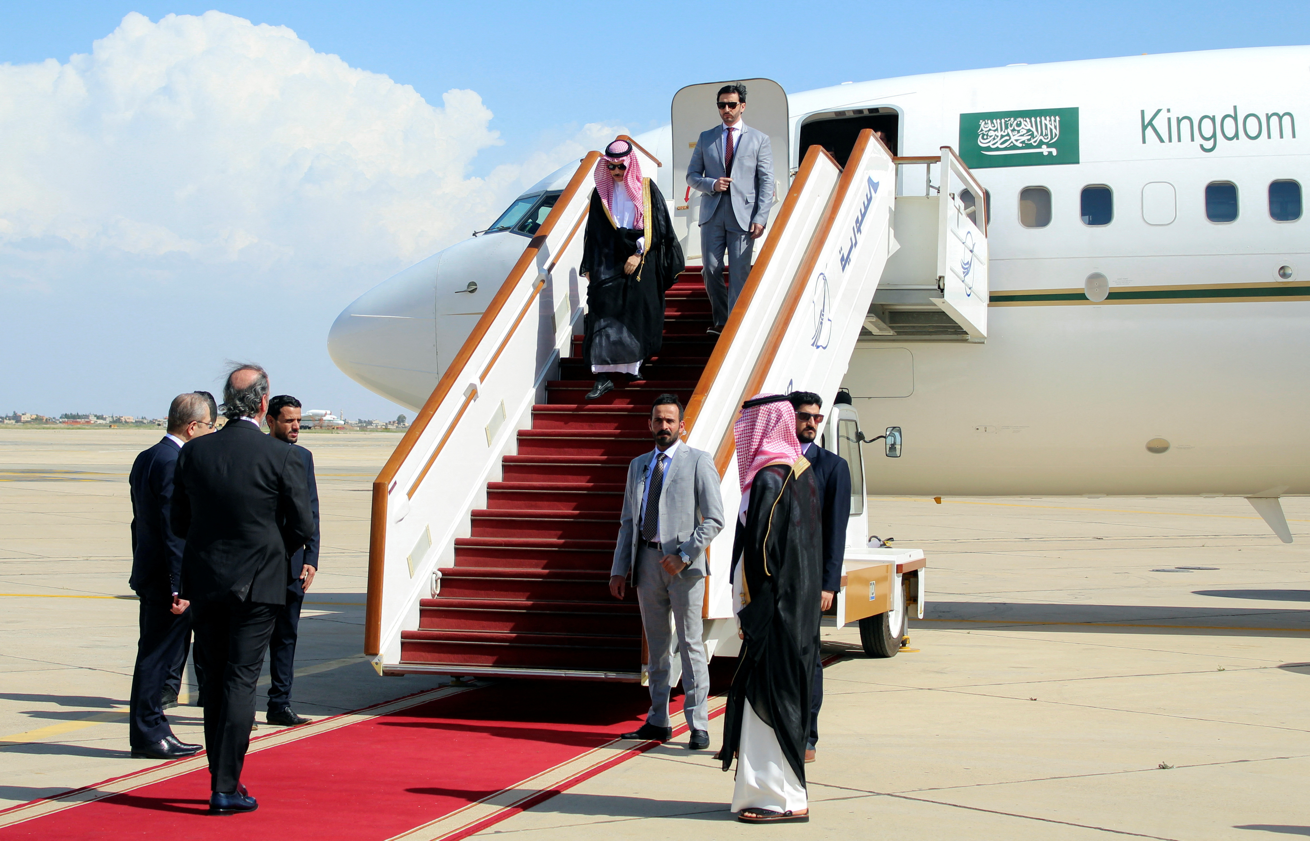 Saudi Foreign Minister Prince bin Farhan disembarks from a plane upon his arrival in Damascus