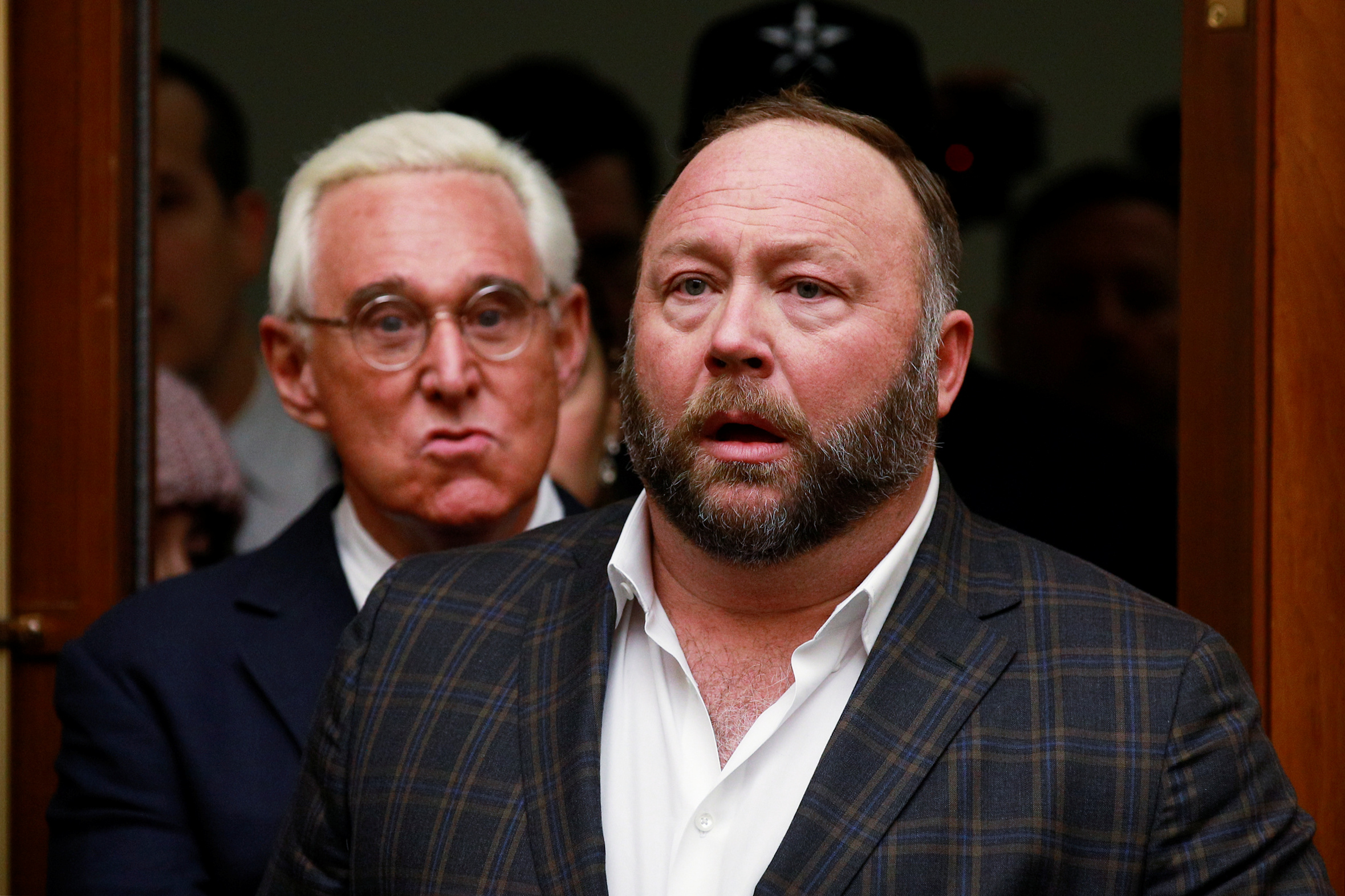 Alex Jones of Infowars is followed by political operative Roger Stone (L) prior to the testimony of Google CEO Sundar Pichai at a House Judiciary Committee hearing “examining Google and its Data Collection, Use and Filtering Practices” on Capitol Hill in Washington, U.S., December 11, 2018. REUTERS/Jim Young