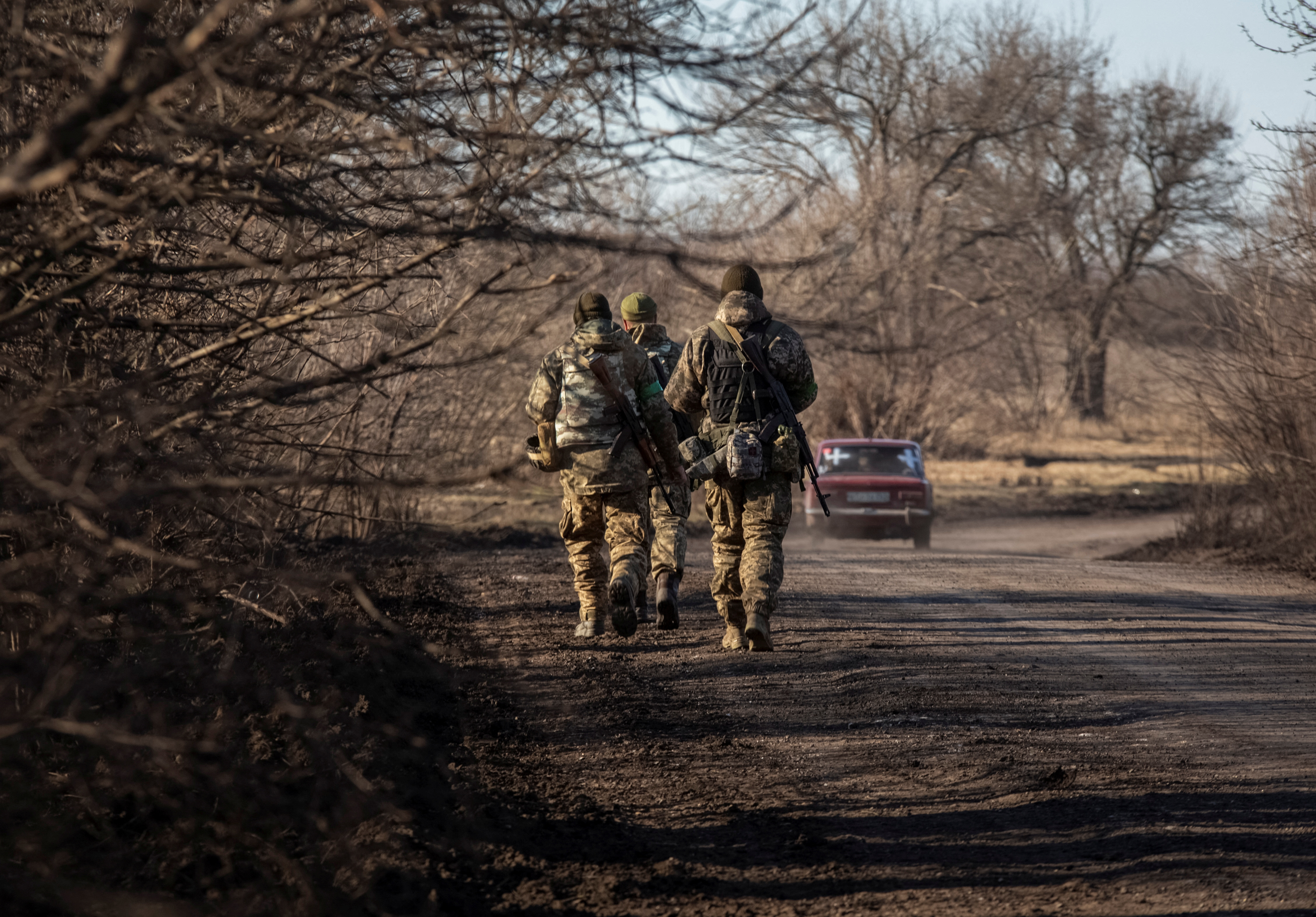 Ukrainian servicemen walk near the frontline near Soledar