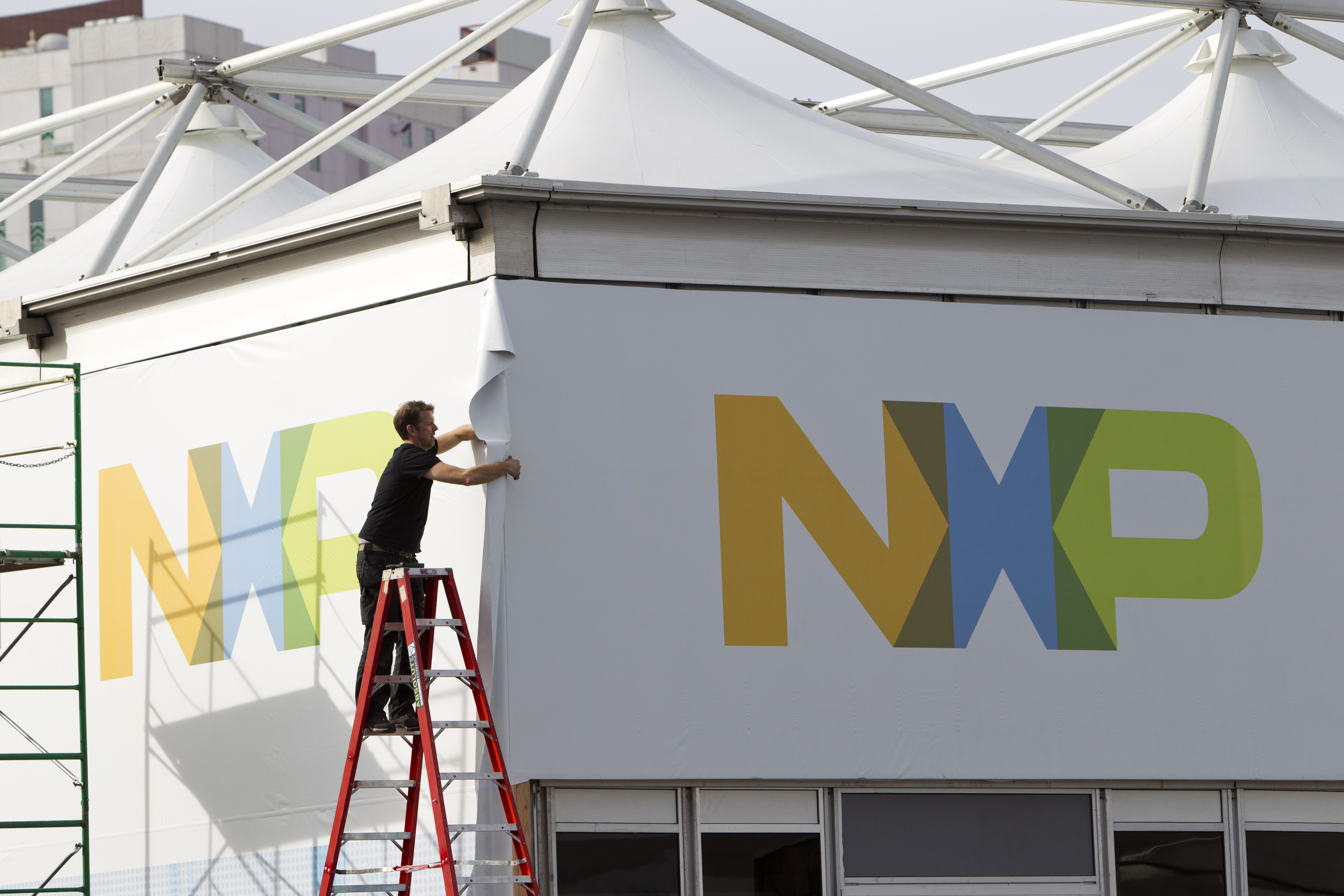 A man works on a tent for NXP Semiconductors in preparation for the 2015 International Consumer Electronics Show (CES) at Las Vegas Convention Center in Las Vegas