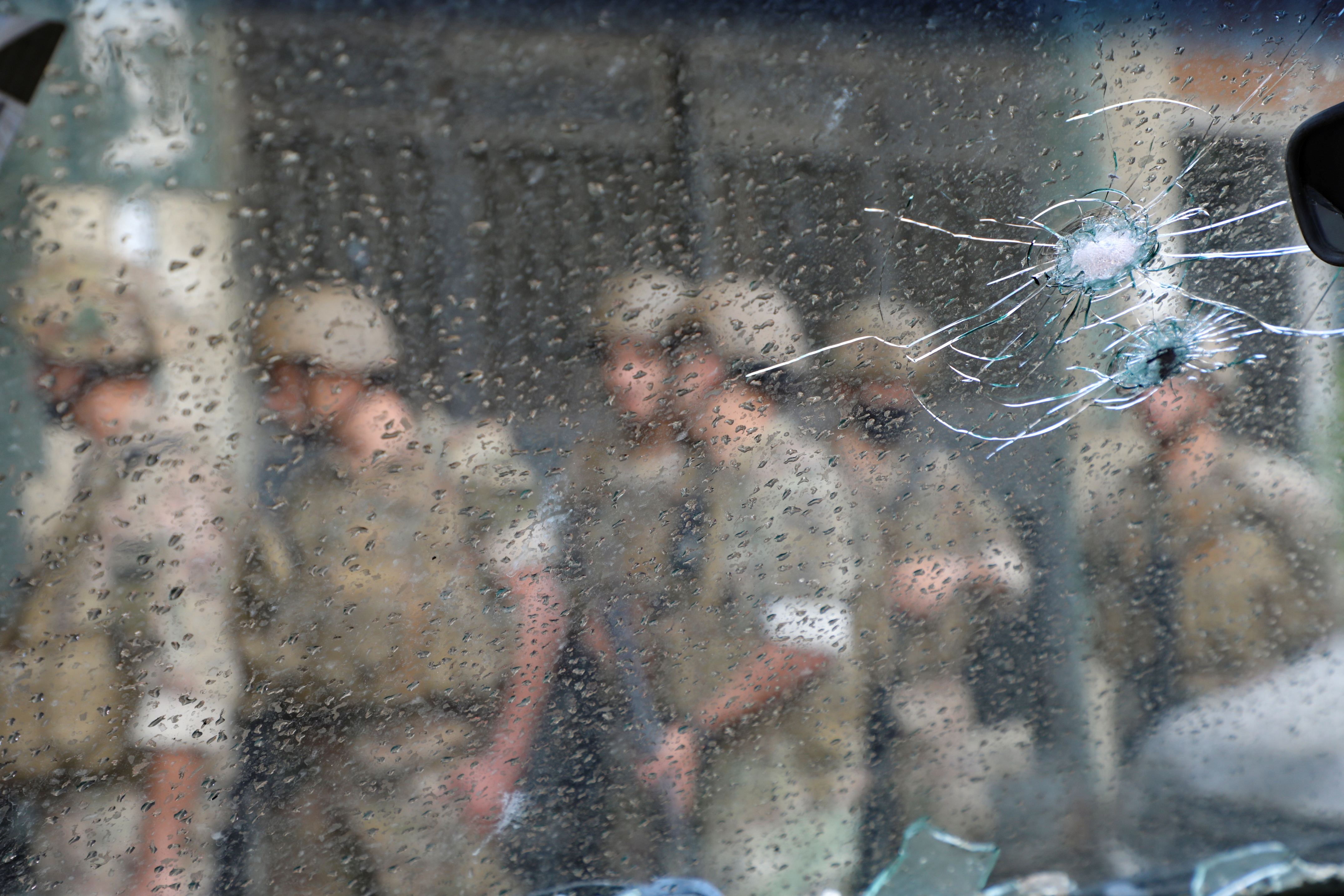 Army soldiers are seen behind a glass with gun holes, after gunfire erupted in Beirut, Lebanon October 14, 2021.  REUTERS/Mohamed Azakir