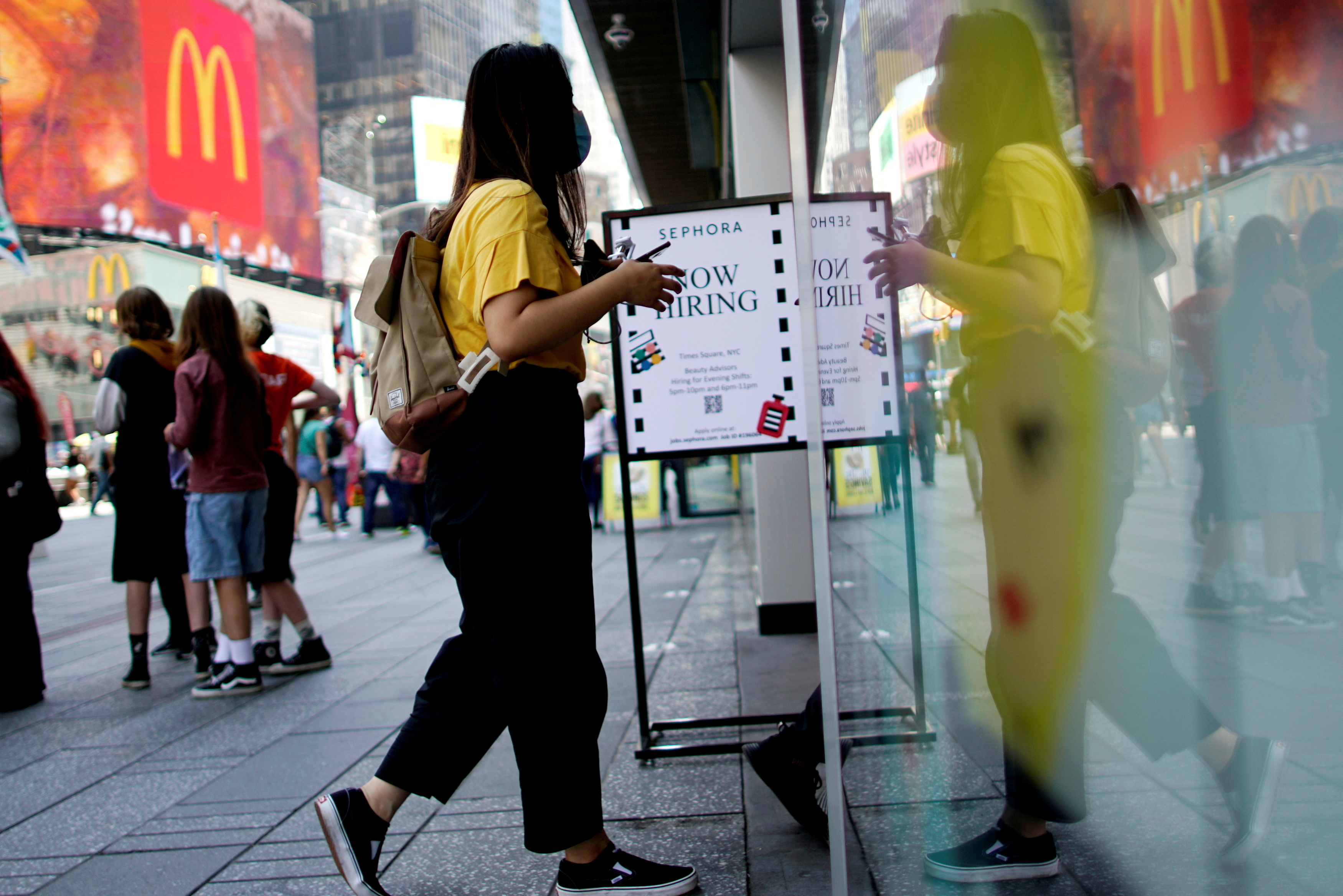 A sign advertising job openings is seen in New York