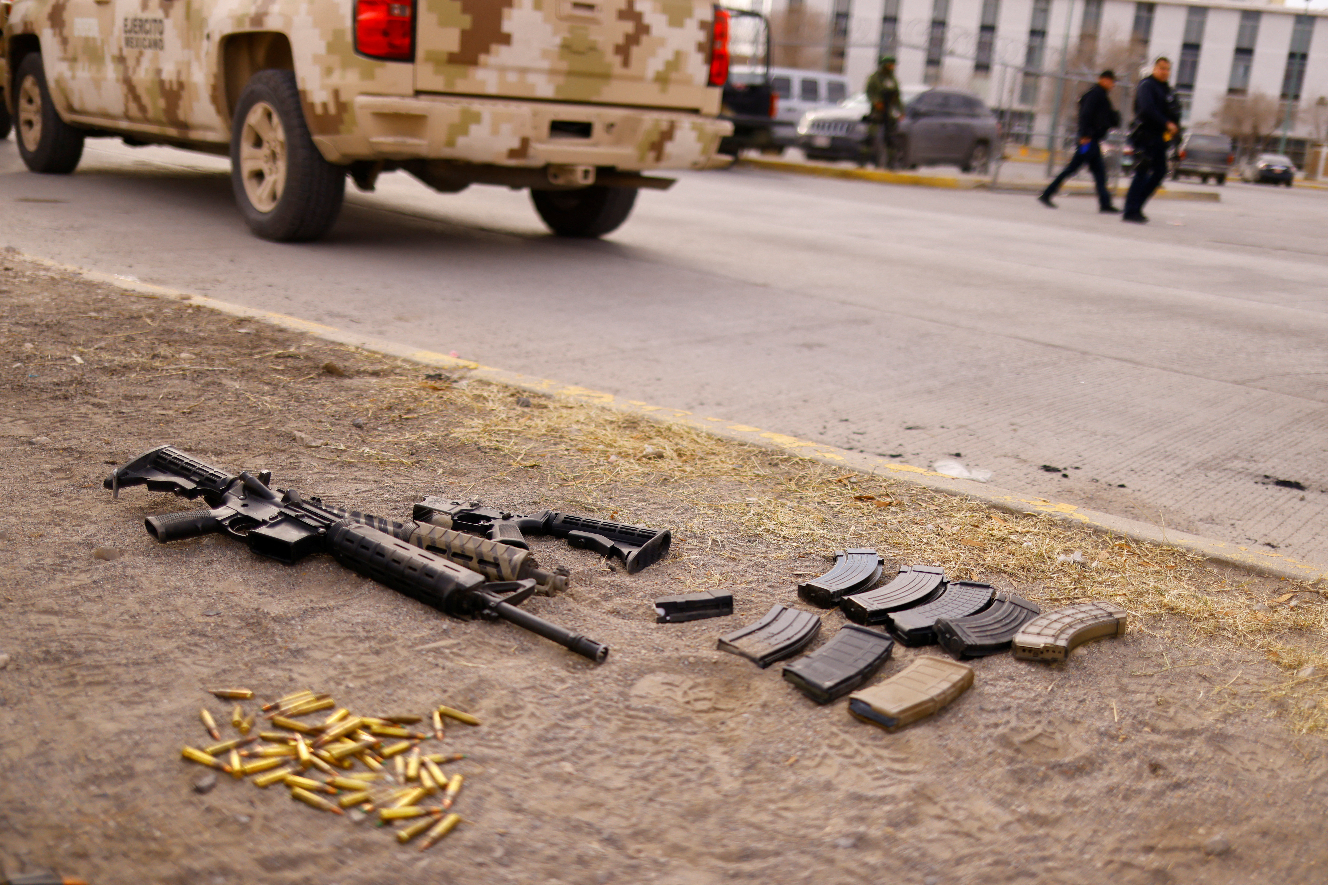 Guns and bullets are seen in front of the Cereso state prison number 3 secured by the security Forces after unknown assailants entered the prison and freed several inmates, resulting in injuries and deaths, in Ciudad Juarez