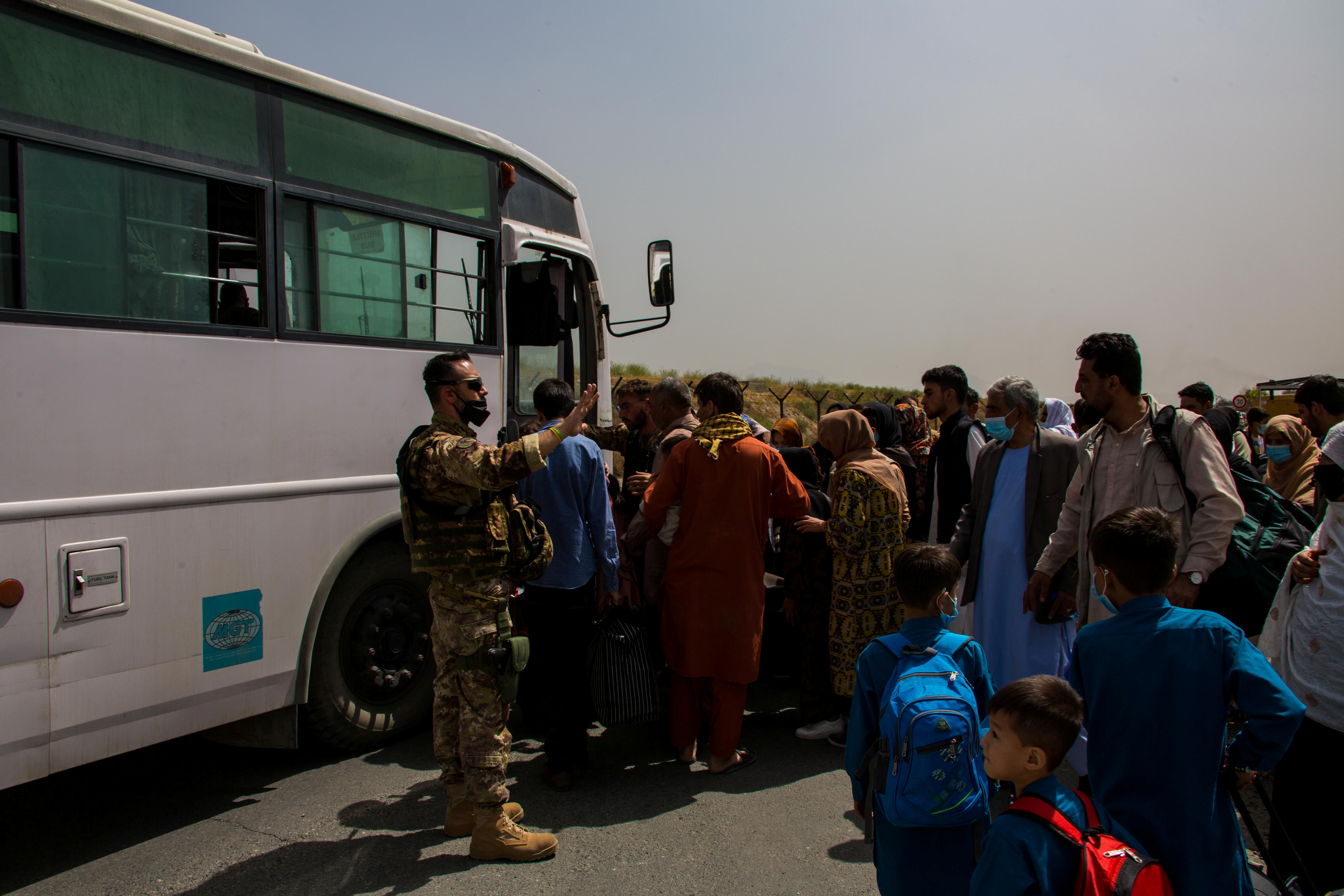German military members process evacuees during an evacuation at Hamid Karzai International Airport, Kabul, Afghanistan, August 28, 2021.  U.S. Marine Corps/Cpl. Davis Harris/Handout via REUTERS. 