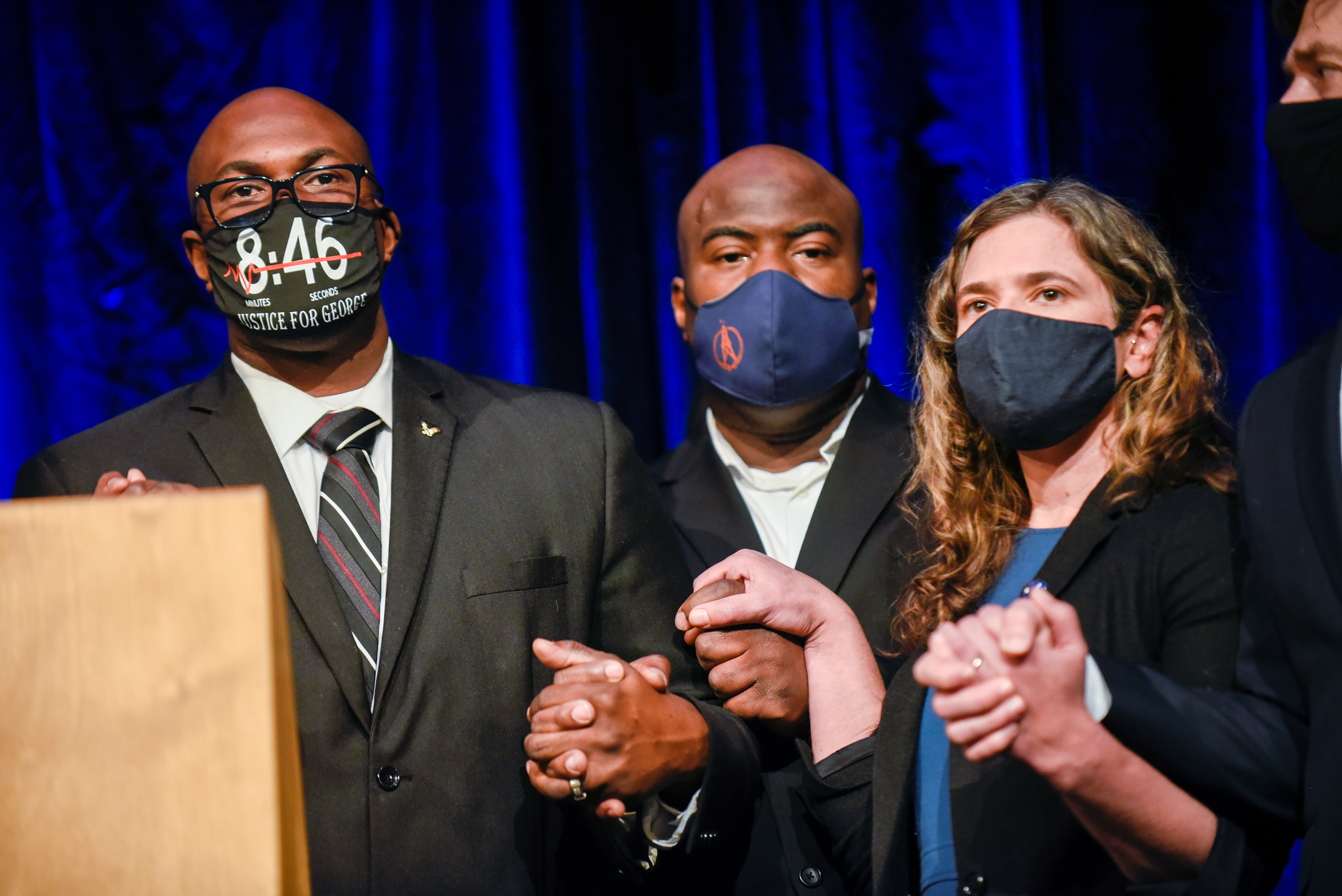 George Floyd's brothers, Philonise and Rodney Floyd, hold hands with City Council President Lisa Bender during a news conference announcing a $27 million dollar settlement with the City of Minneapolis at the Minneapolis Convention Center at the end of the first week of the trial of former police Derek Chauvin, who is facing murder charges in the death of George Floyd, in Minneapolis, Minnesota, U.S., March 12, 2021. REUTERS/Nicholas Pfosi