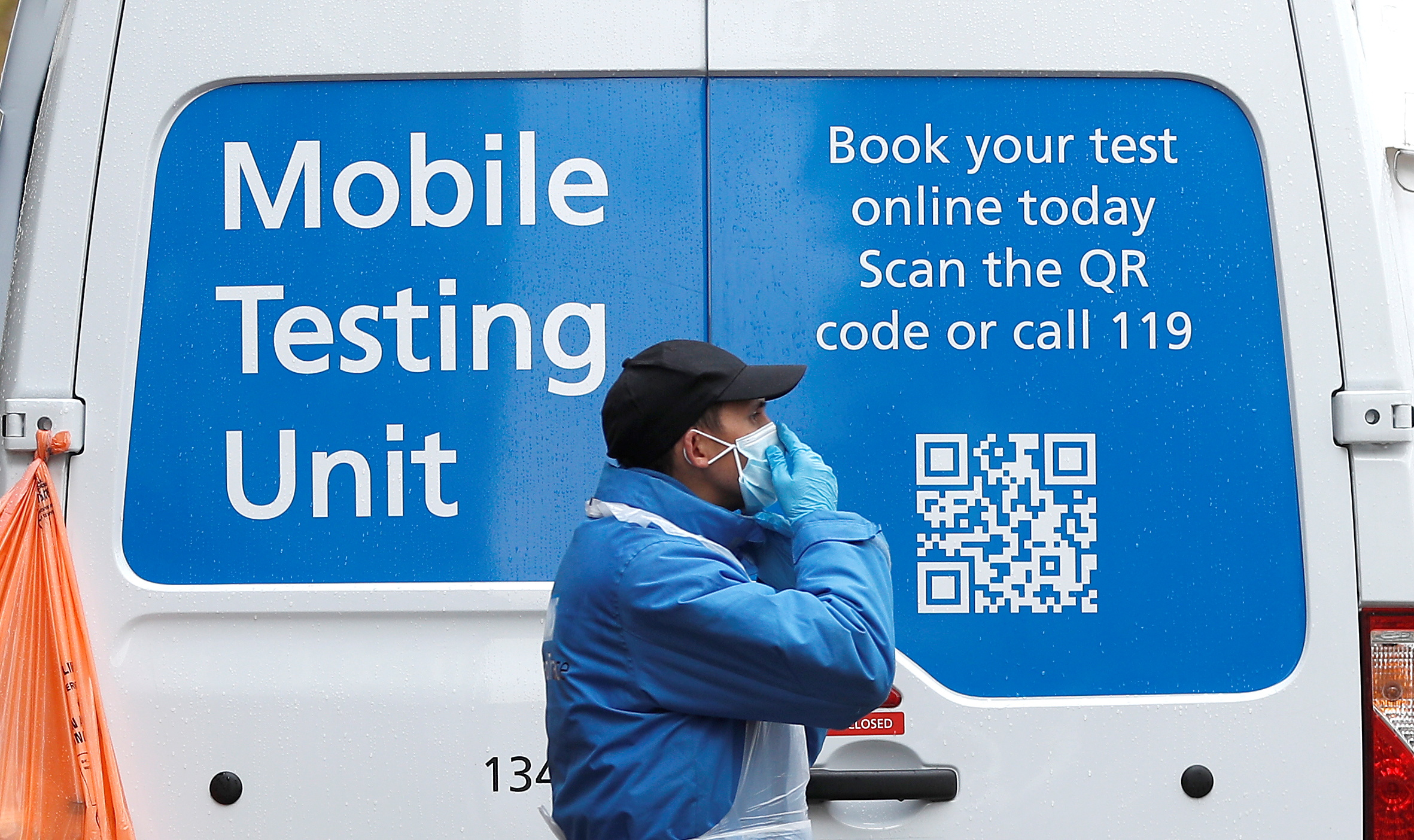 An NHS worker stands next to a coronavirus disease (COVID-19) mobile testing unit in Tower Hamlets, London