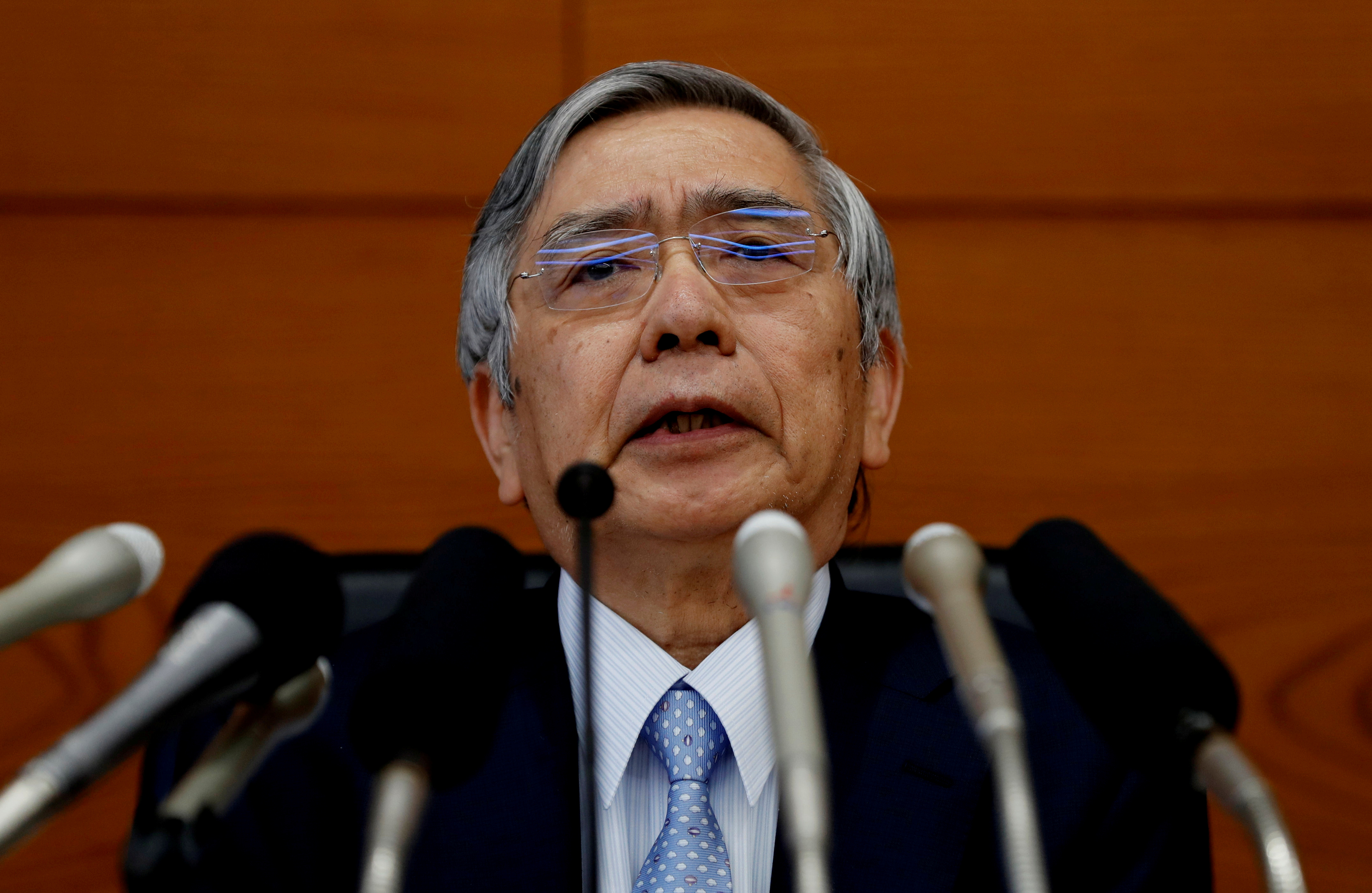 FILE PHOTO: Bank of Japan (BOJ) Governor Haruhiko Kuroda attends a news conference at the BOJ headquarters in Tokyo
