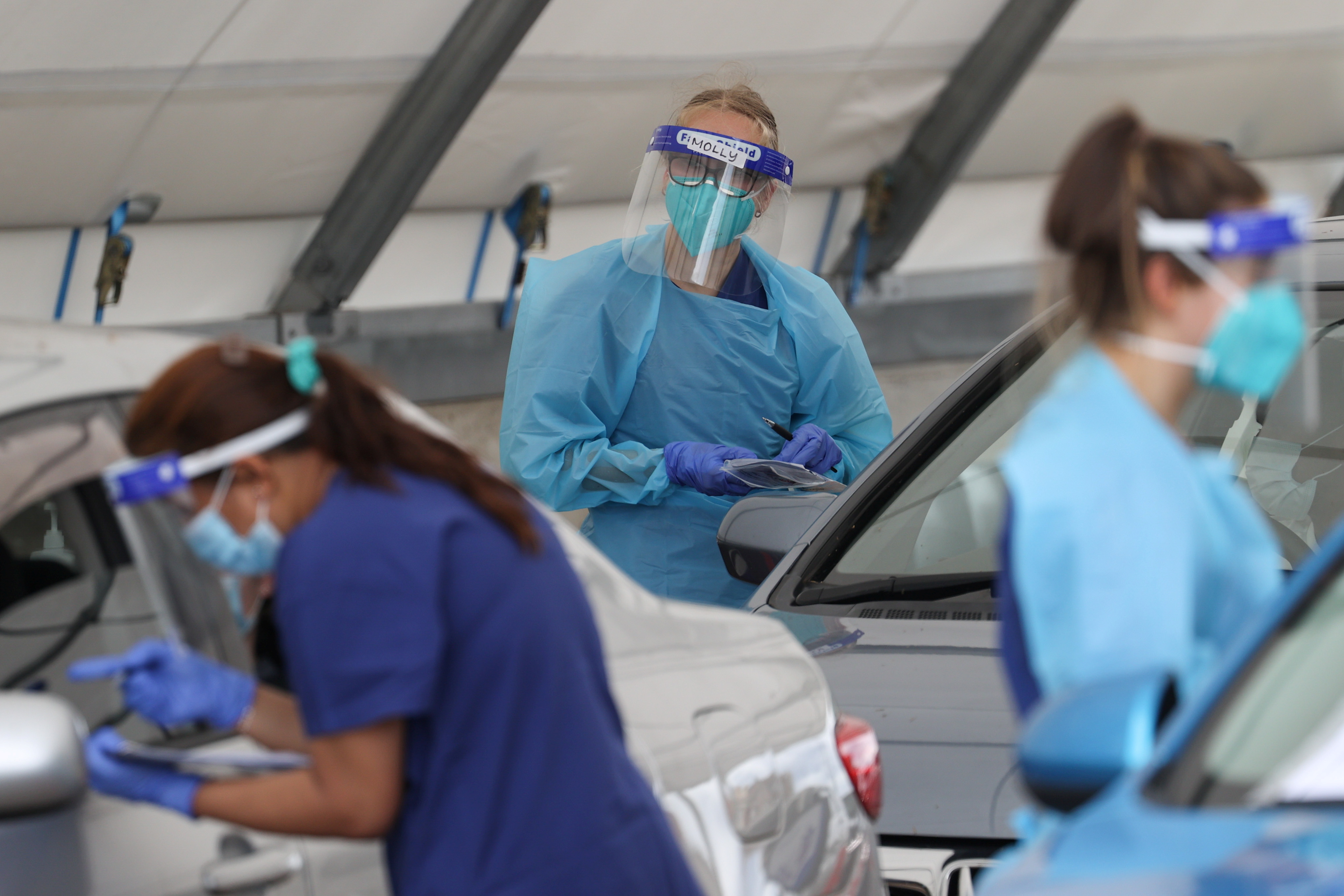 Medical workers administer tests at the Bondi Beach drive-through coronavirus disease (COVID-19) testing centre in the wake of an outbreak in Sydney, Australia, December 22, 2020. REUTERS/Loren Elliott