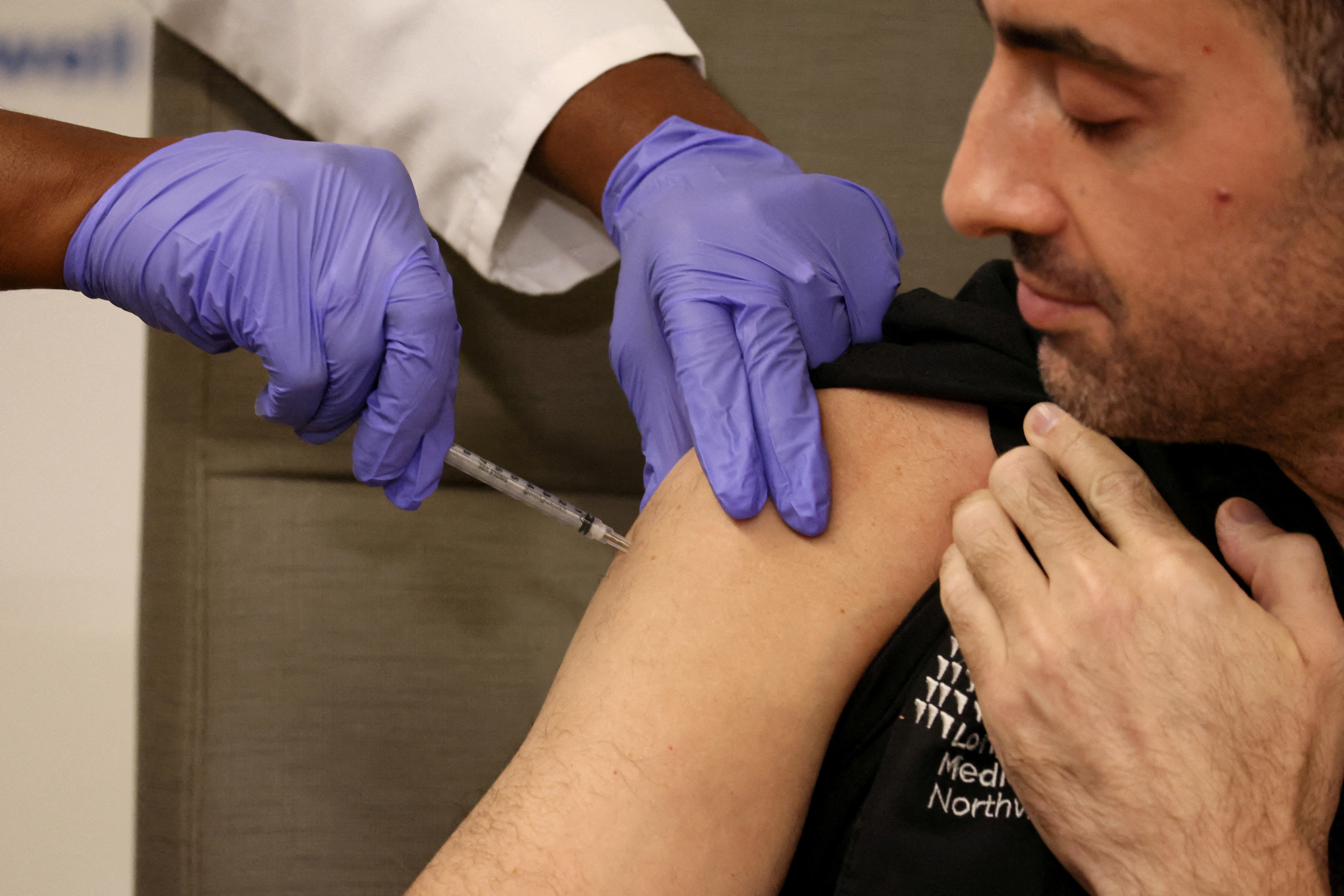 Health workers receive the updated coronavirus disease (COVID-19) vaccine in New York
