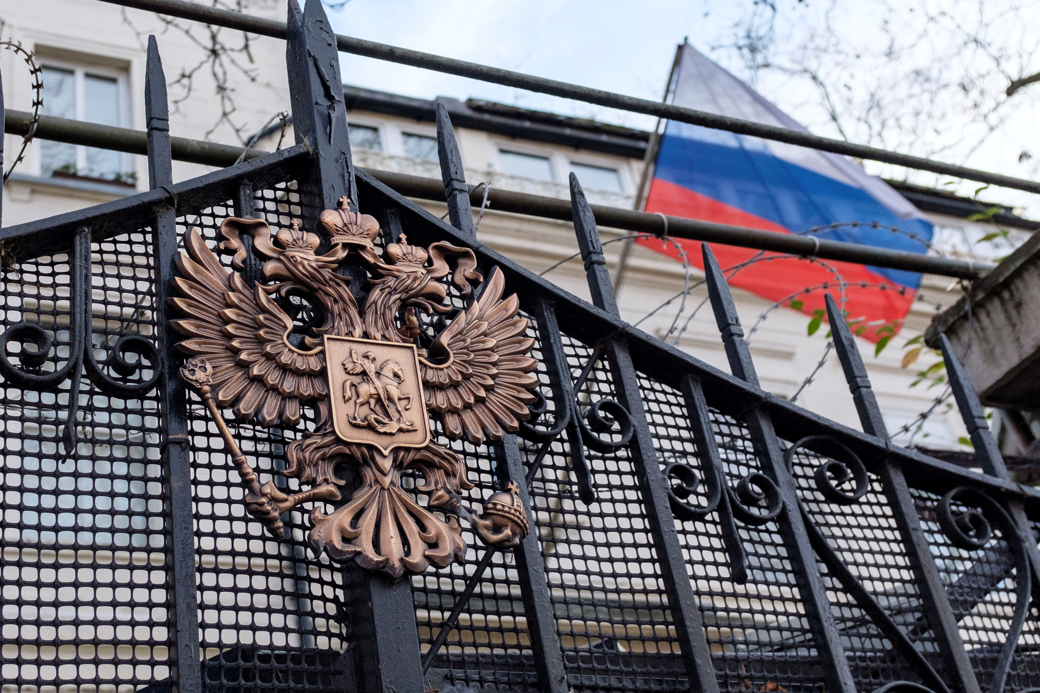 An emblem is displayed on the gate of the Russian Embassy in London