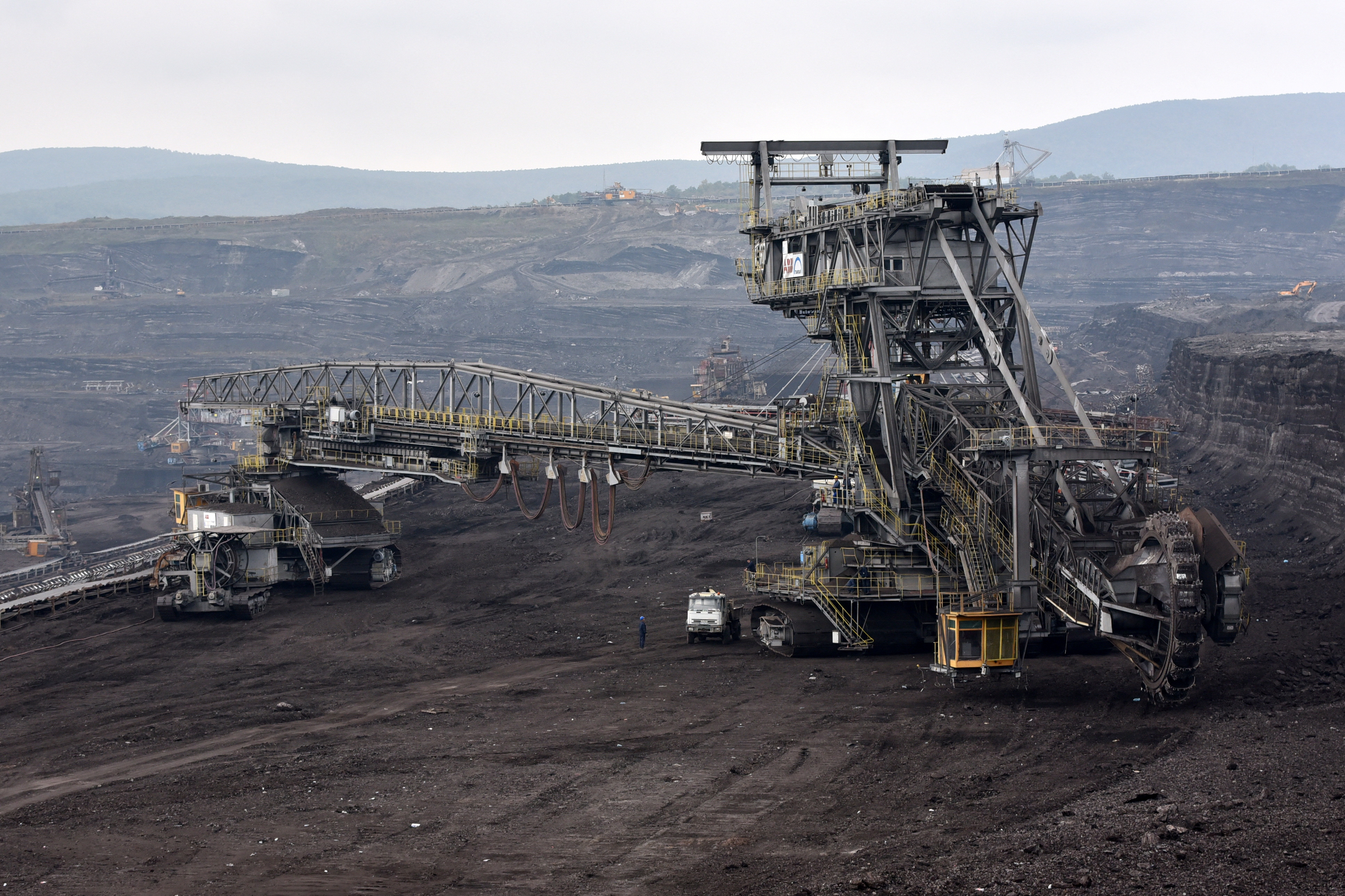 A worker stands at a lignite mine, near the town of Obiliq