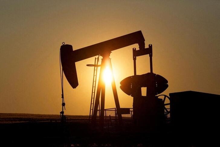 An oil pump jack pumps oil in a field near Calgary