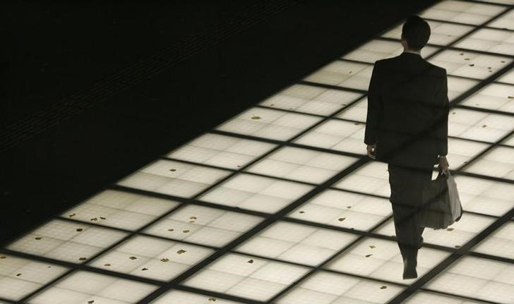 A man walks on an illuminated walkway in Tokyo