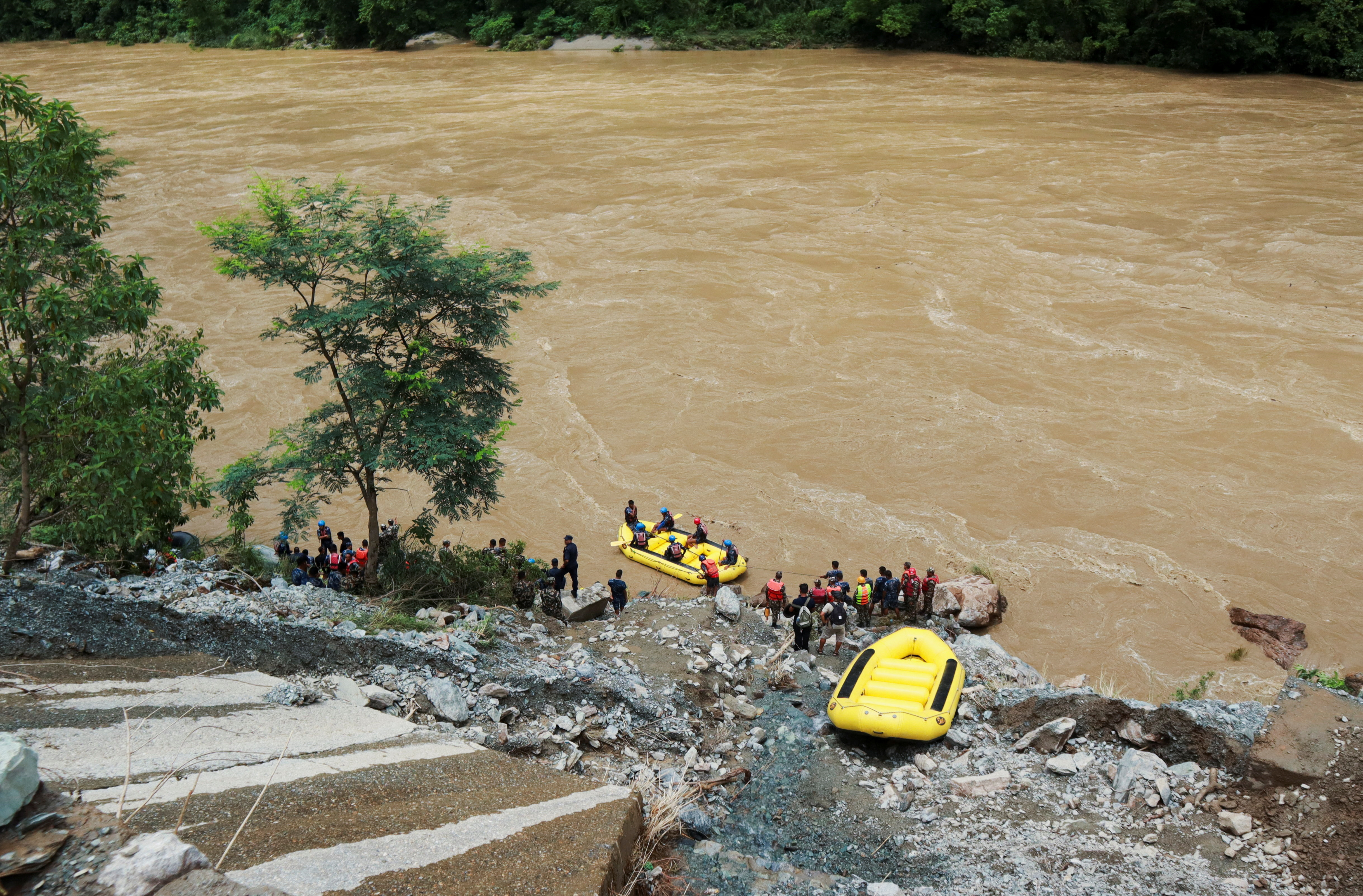 Nepal searches for people missing after landslides sweep two buses into river