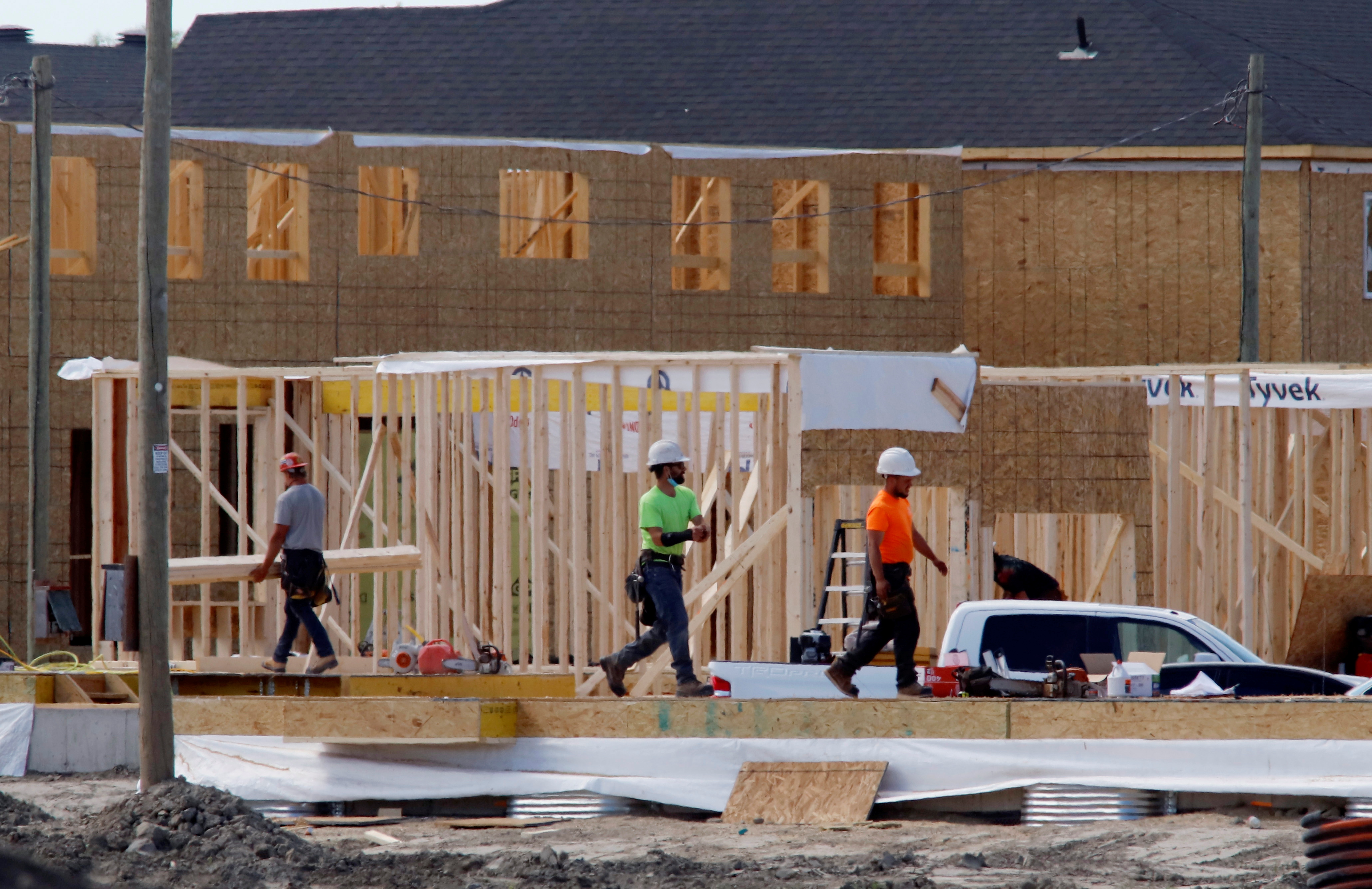 Construction workers work on new homes in Ottawa