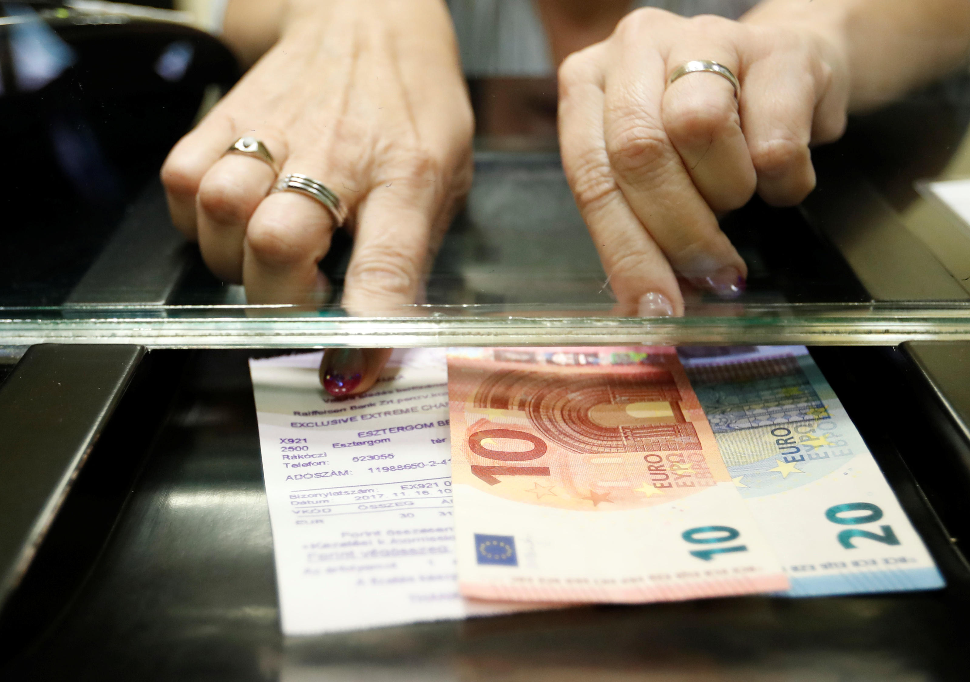 Hungarian woman exchanges forints for euros at a currency exchange shop in Esztergom