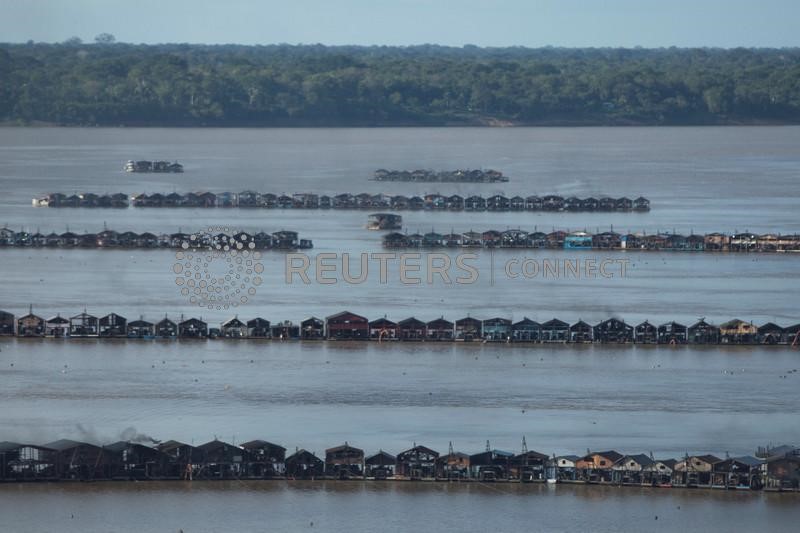 An aerial view shows hundreds of dredging rafts operated by illegal miners who have gathered in a gold rush on the Madeira, a major tributary of the Amazon river, in Autazes, Amazonas state, Brazil November 23, 2021. REUTERS/Bruno Kelly