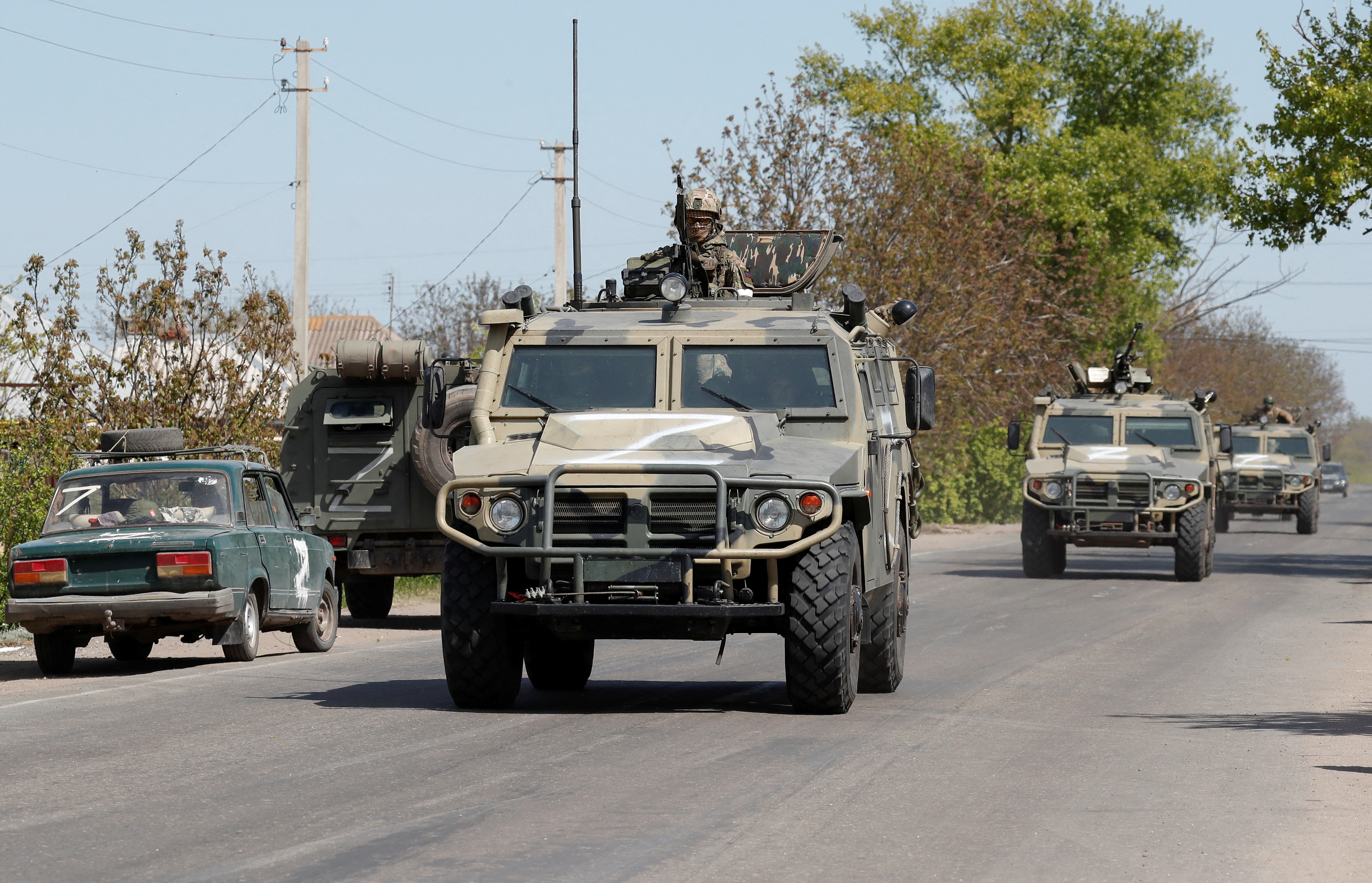 A convoy of pro-Russian troops moves along a road in the Donetsk region