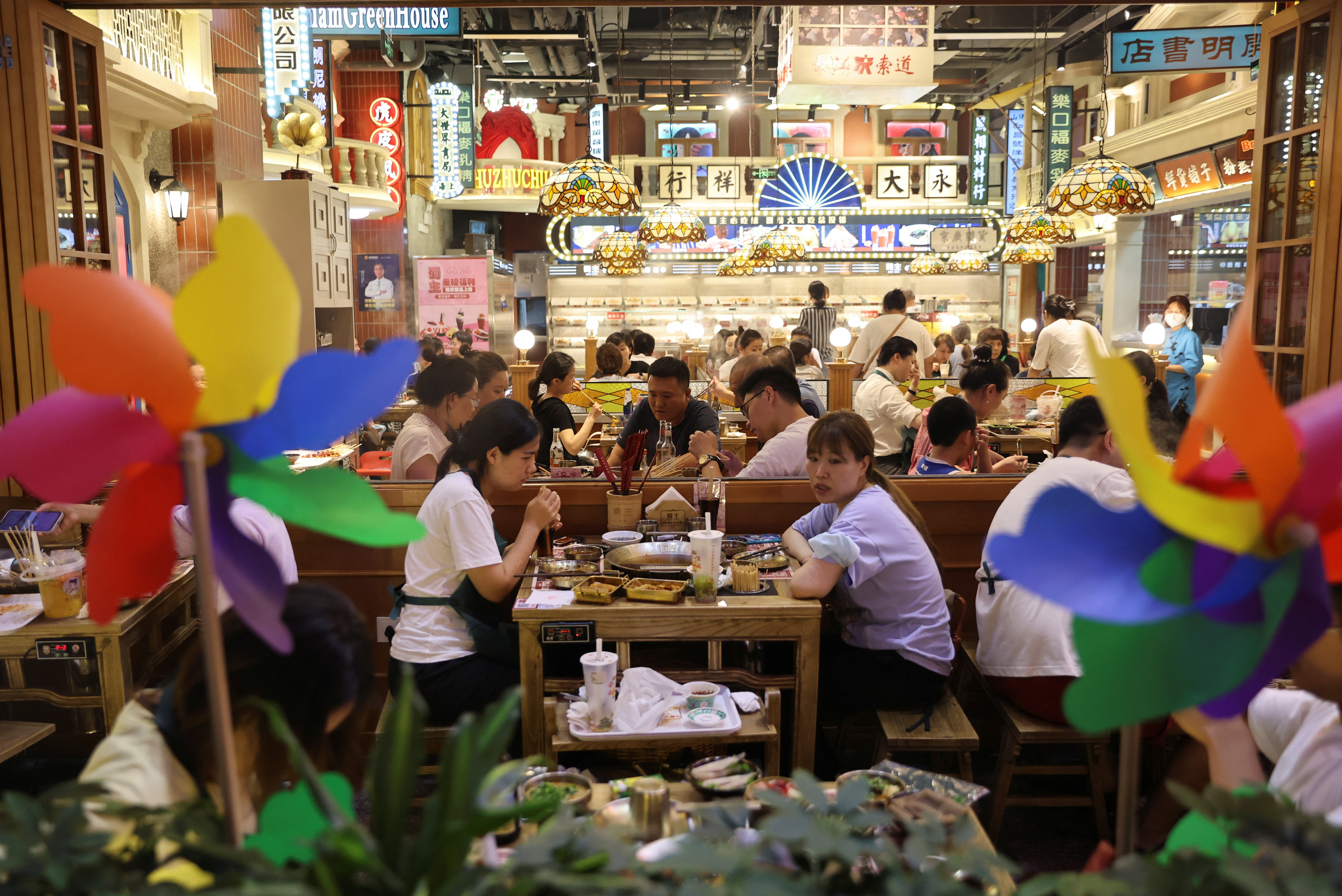 Customers dine at a restaurant in a shopping area in Beijing