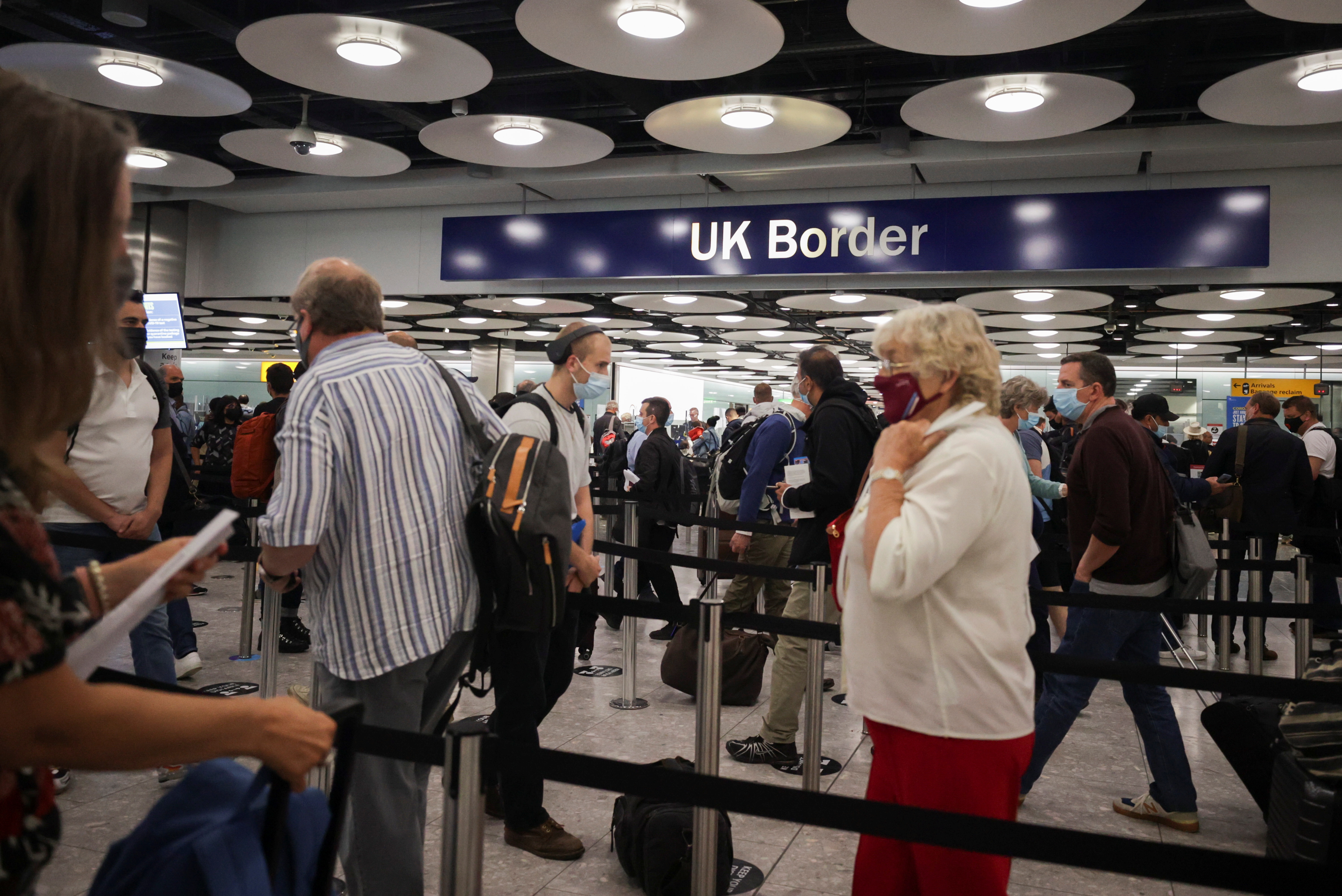 Arriving passengers queue at UK Border Control at the Terminal 5 at Heathrow Airport in London