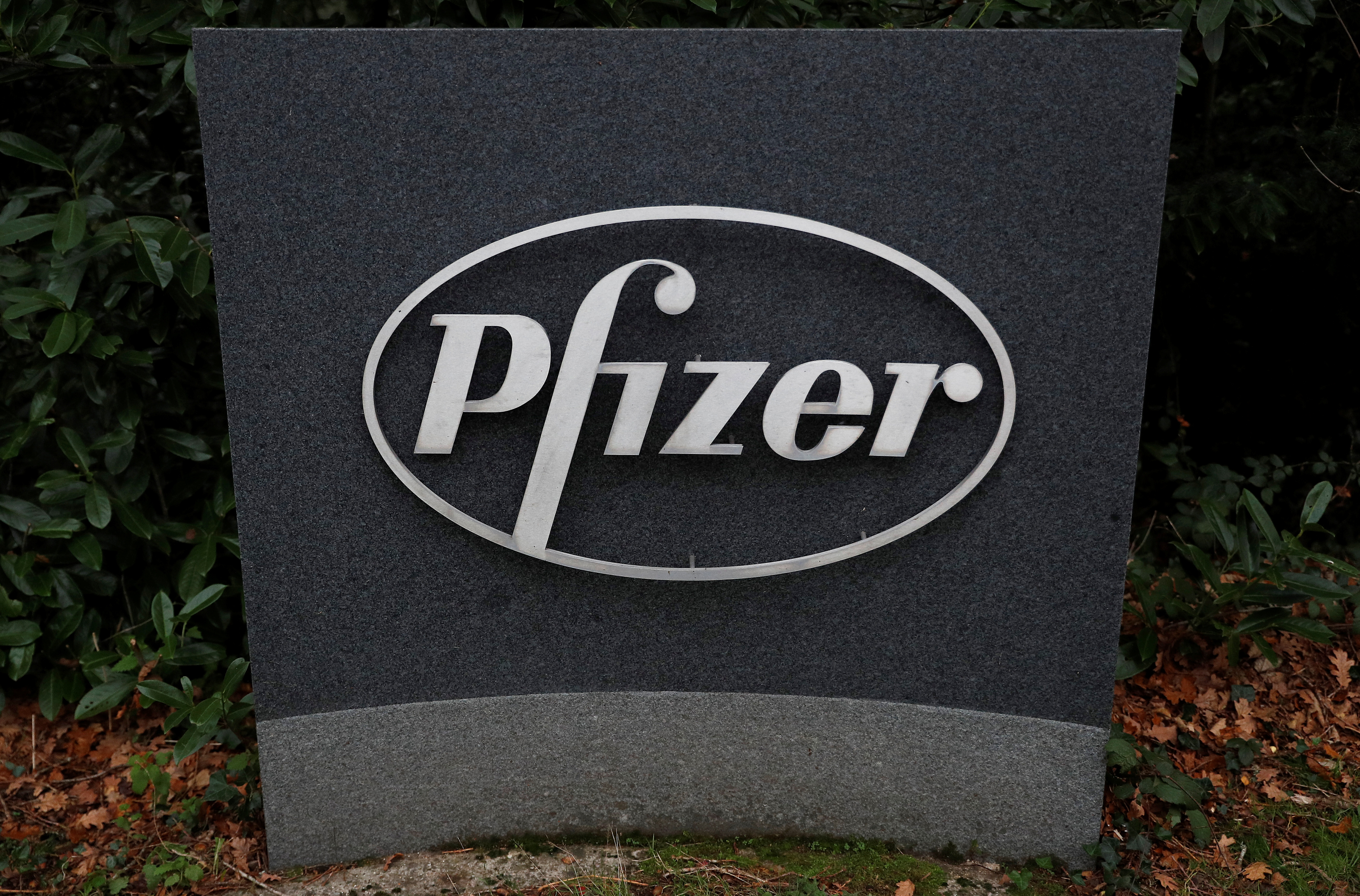 Pfizer logo is seen at the entrance to Pfizer UK headquarters in Tadworth