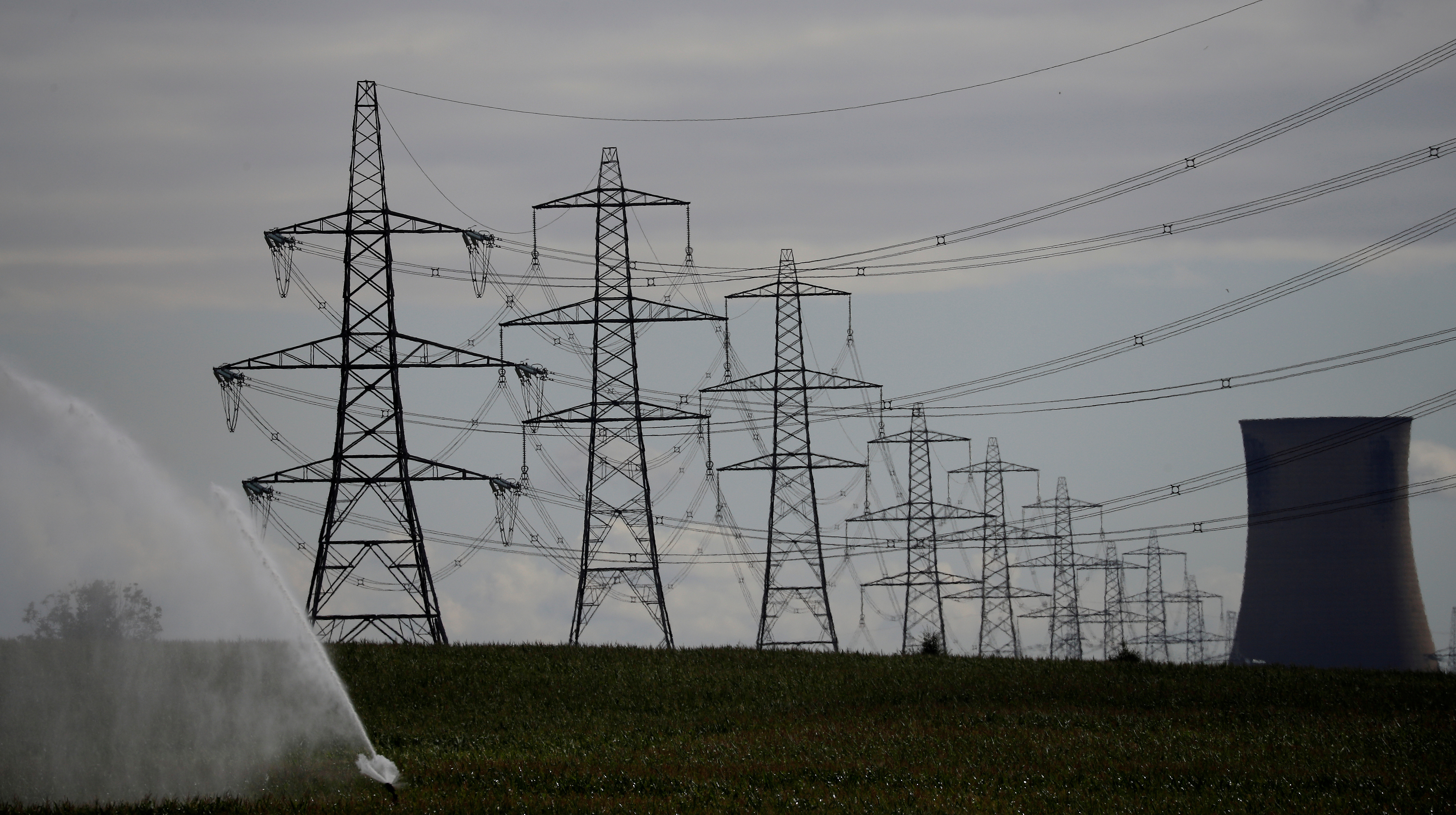 Electricity pylons and a cooling tower from Eggborough power station are seen above a farmers' field in Kellingley