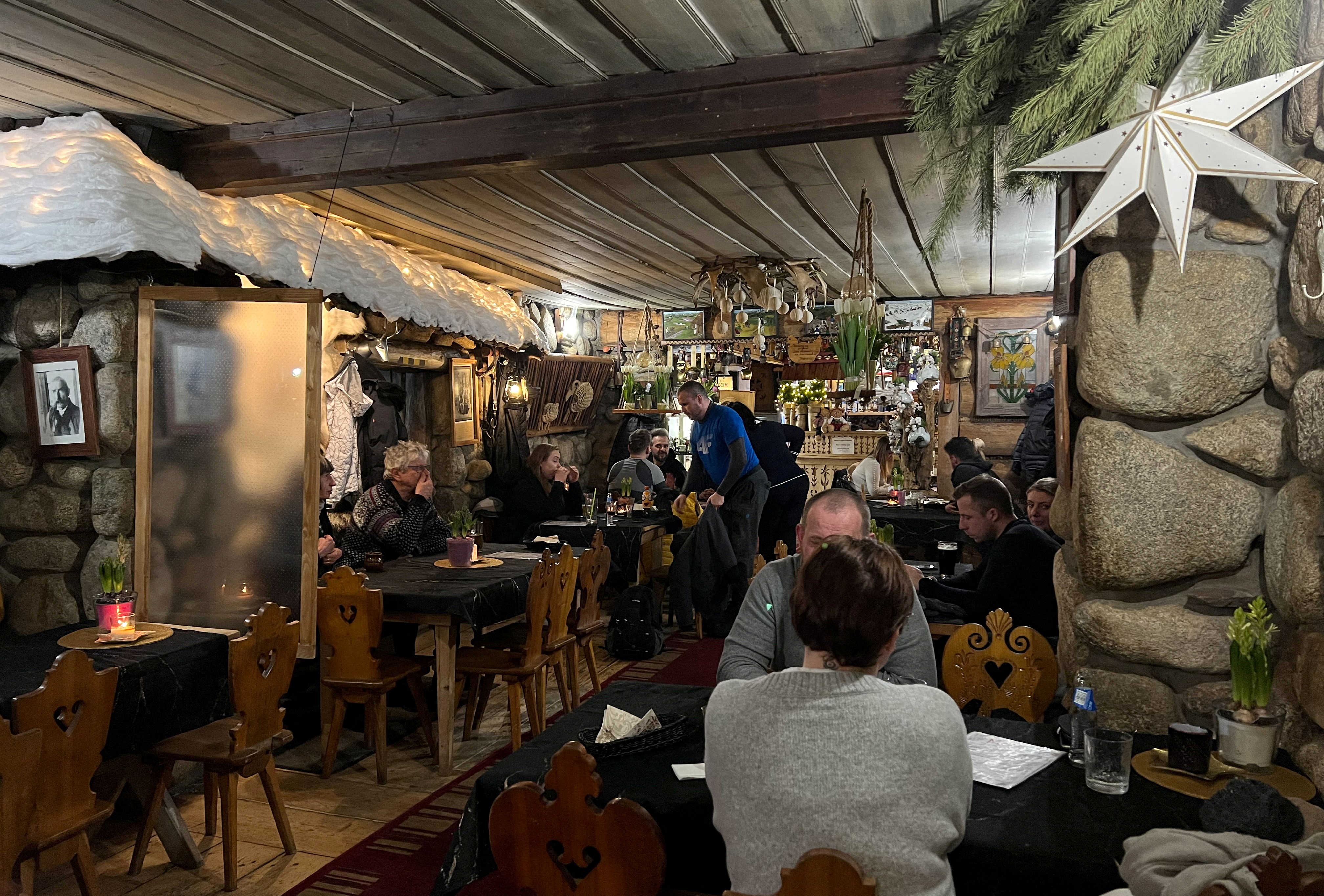 People sit and eat at Karczma Obrochtowka restaurant, in Zakopane