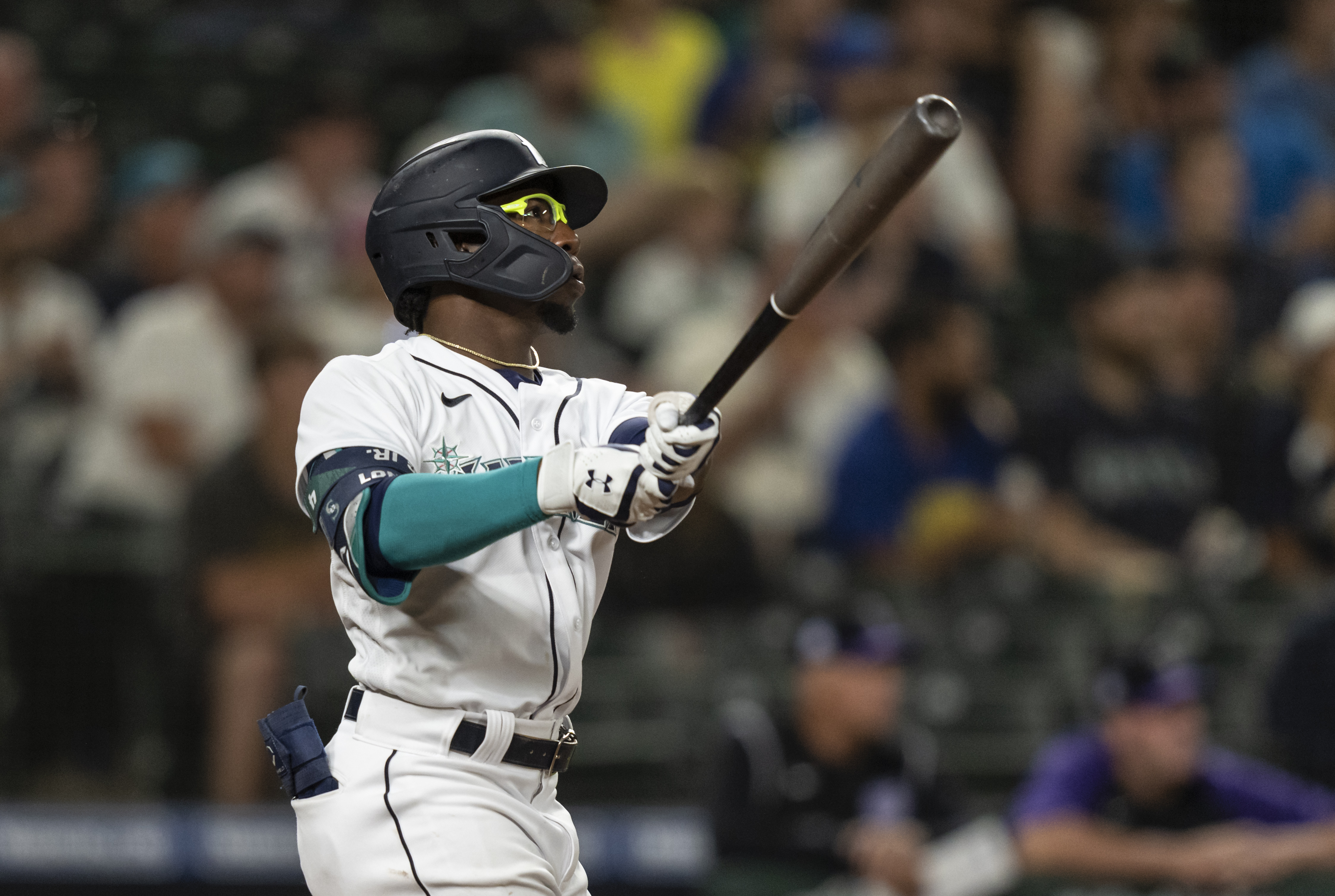 Jun 22, 2021; Seattle, Washington, USA;  Seattle Mariners leftfielder Shed Long Jr. (4) hits a solo home run off of Colorado Rockies relief pitcher Tyler Kinley (40) during the eighth inning of a game at T-Mobile Park. Mandatory Credit: Stephen Brashear-USA TODAY Sports