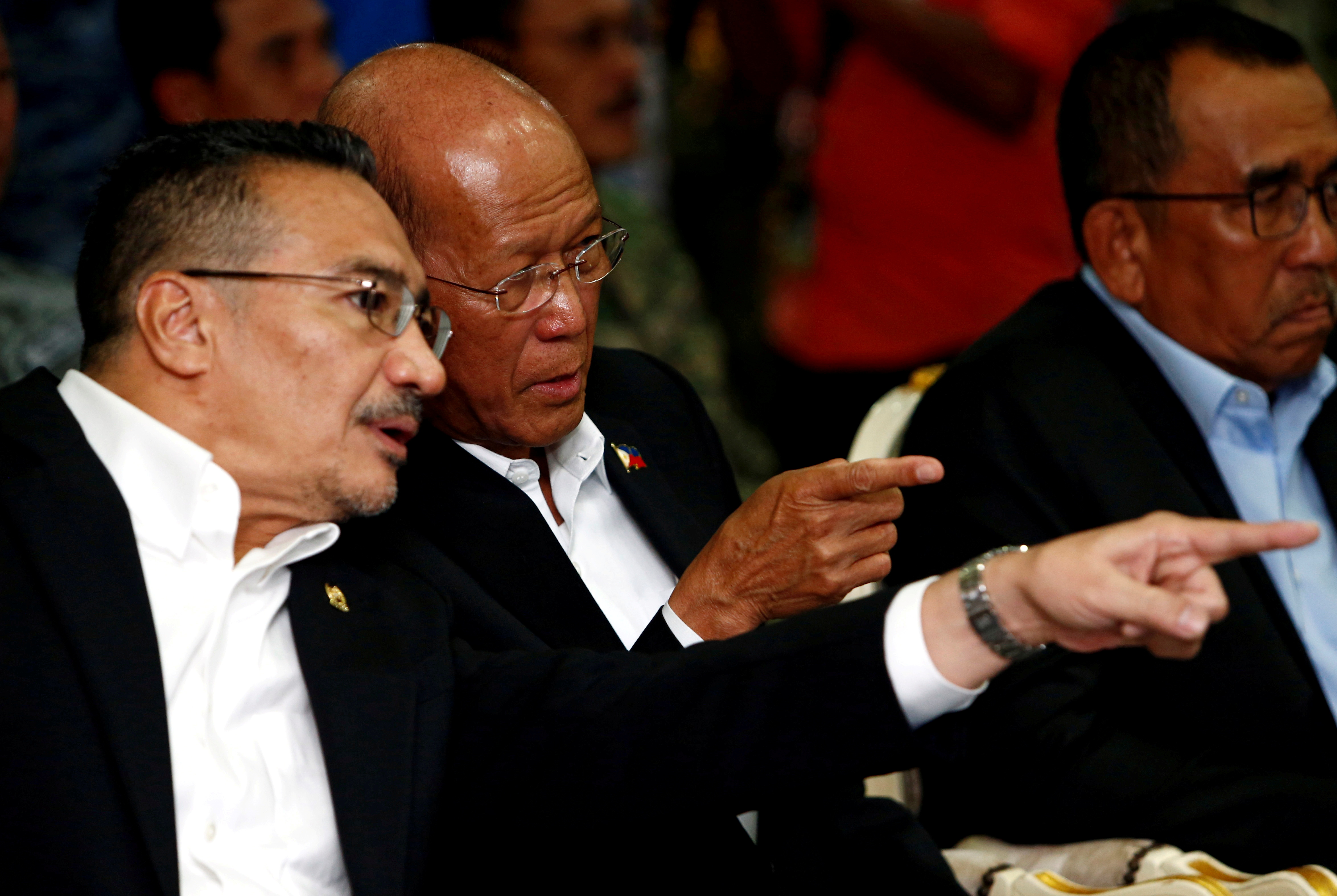 Malaysia's Defence Minister Hishammuddin Hussein speaks to Philippines's Secretary of National Defence Delfin Lorenzana during the launch of the Trilateral Air Patrol at the Royal Malaysian Air Force base in Subang
