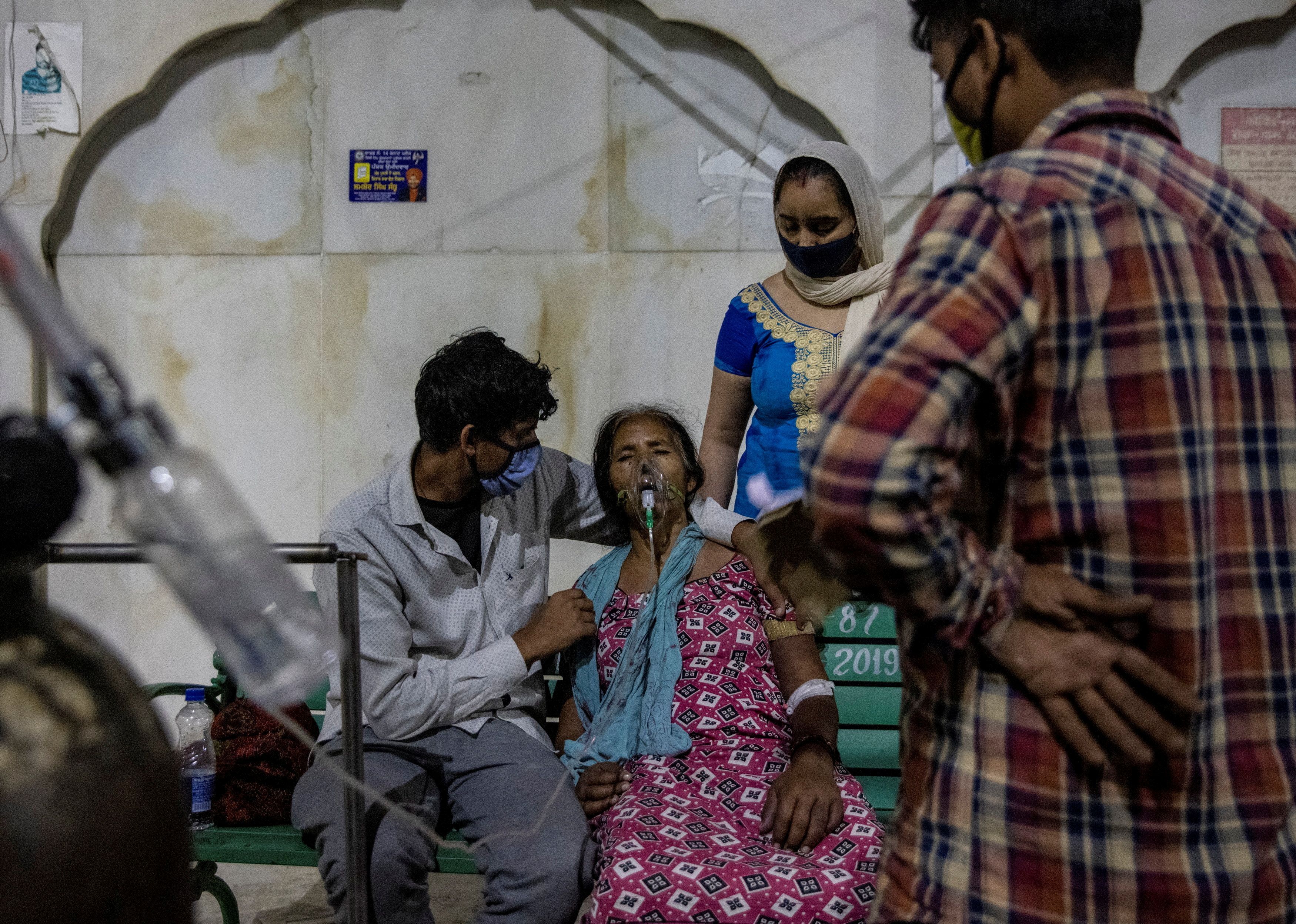 A woman with a breathing problem receives oxygen support for free at a Gurudwara, in Ghaziabad