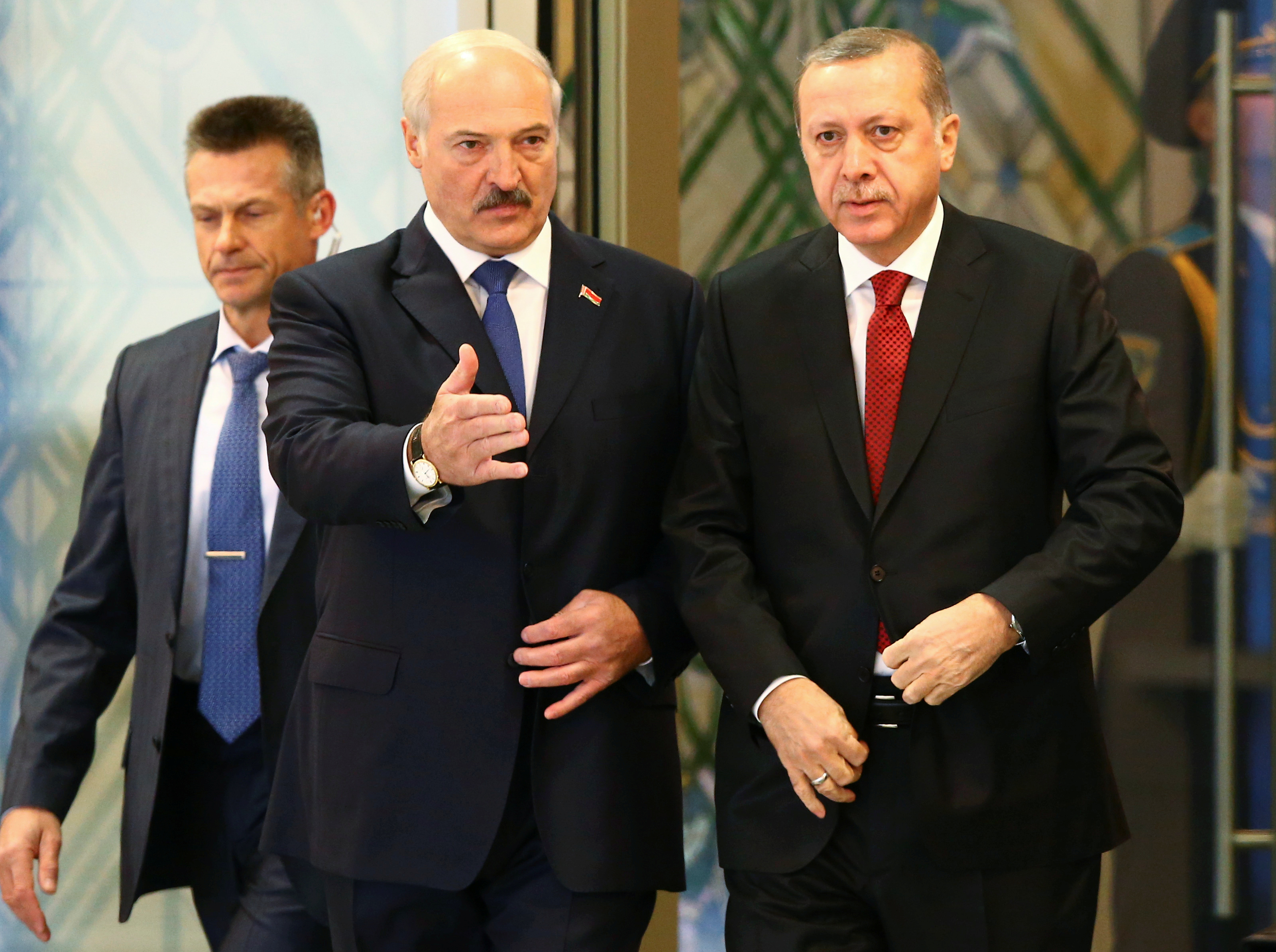 Belarussian President Lukashenko gestures to Turkish President Erdogan during their meeting in Minsk