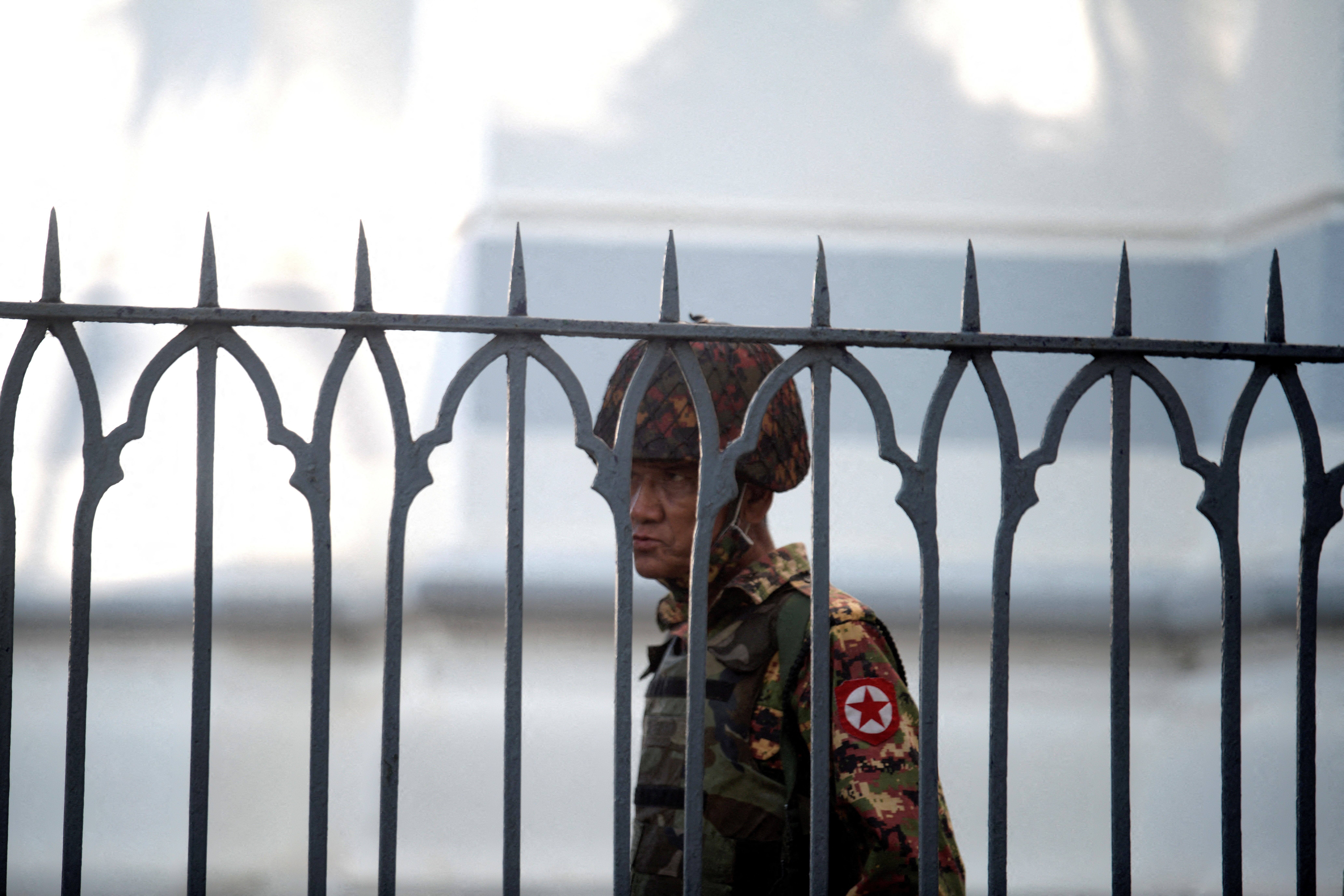 A Myanmar soldier looks on as he stands inside city hall after soldiers occupied the building, in Yangon