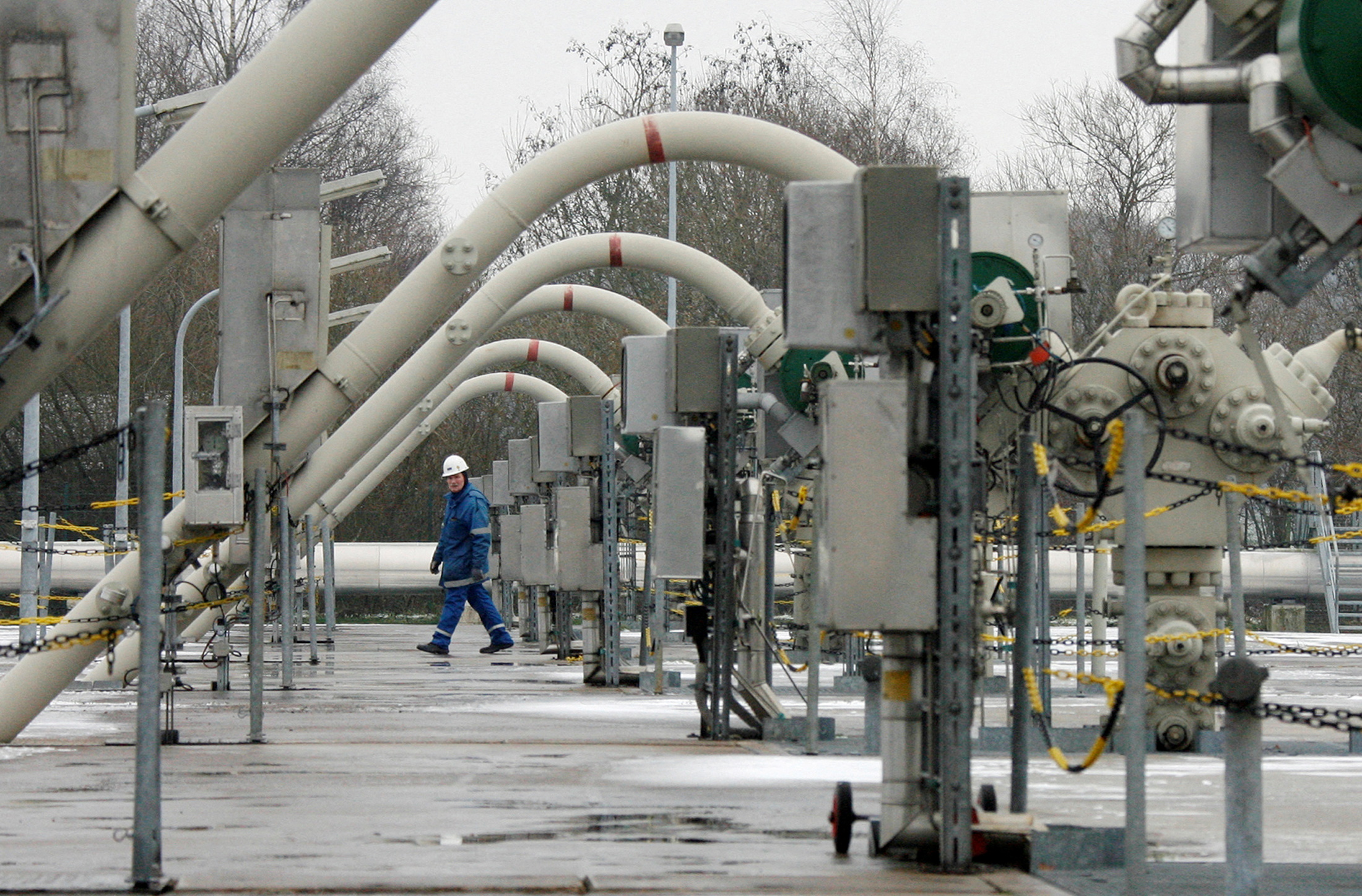 A technician walks between flow lines at the WINGAS gas storage facility in Rehden