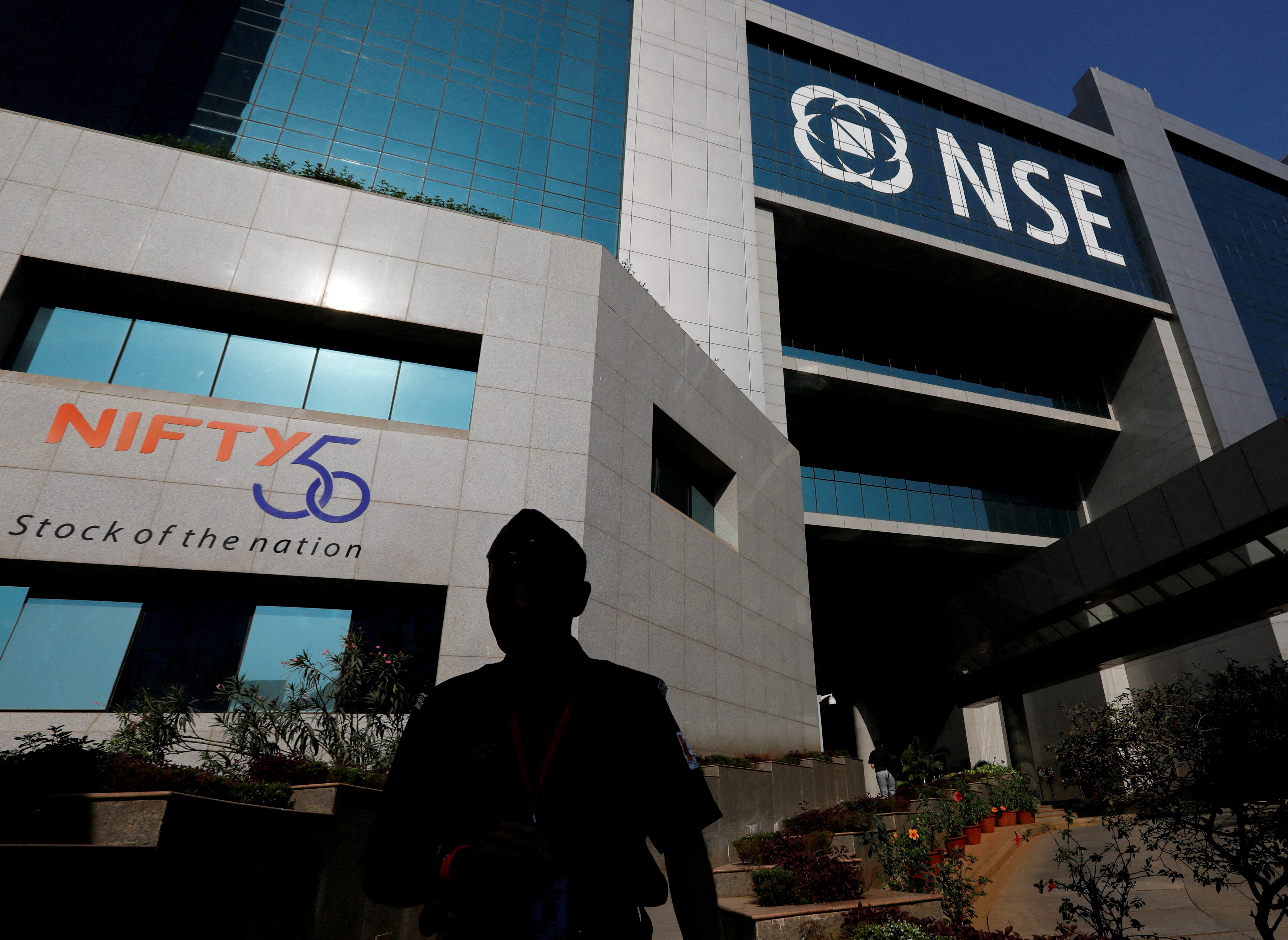 A guard walks past the NSE (National Stock Exchange) building in Mumbai