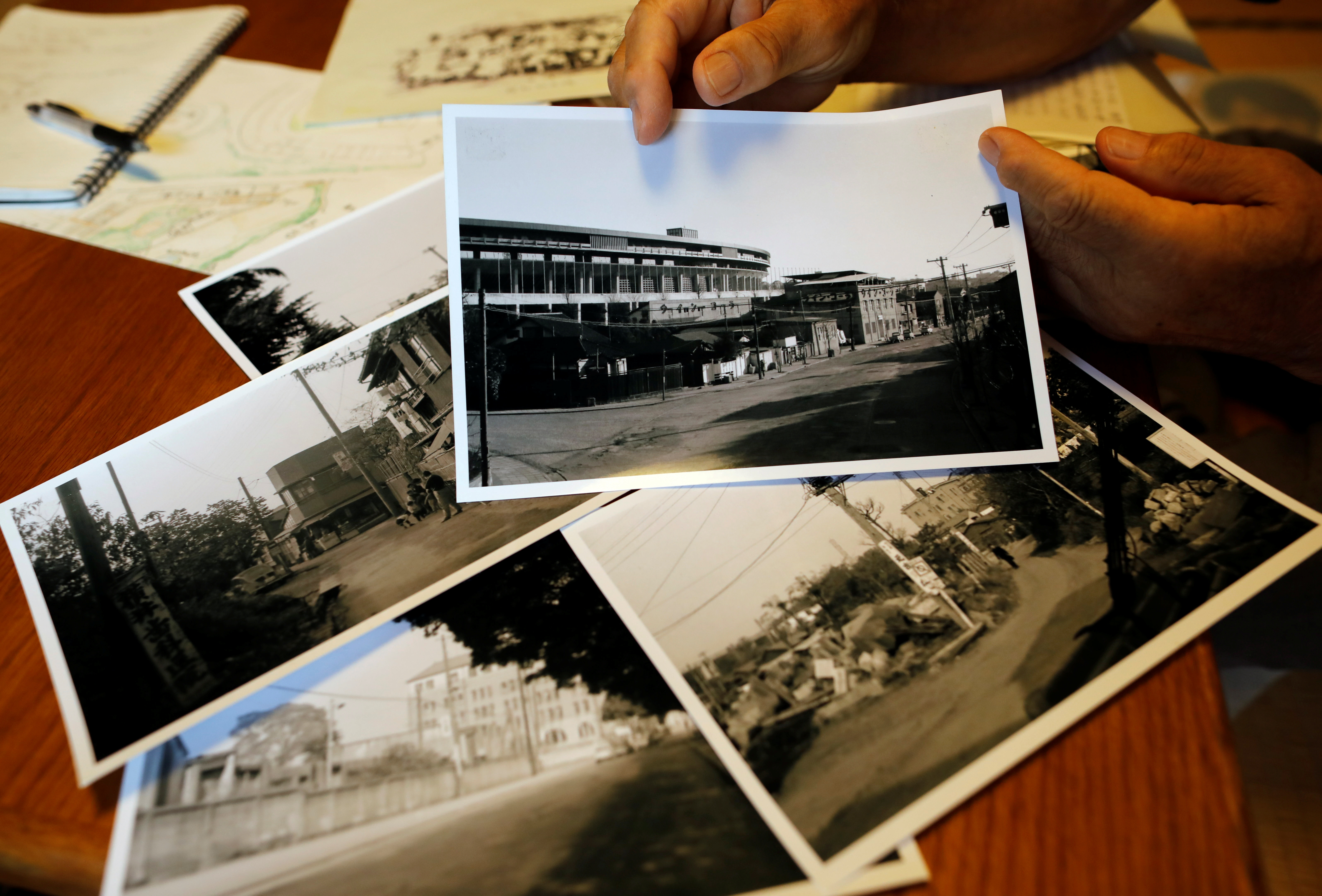 Kohei Jinno shows his old photos of previous national stadium neighboring at his house in Tokyo