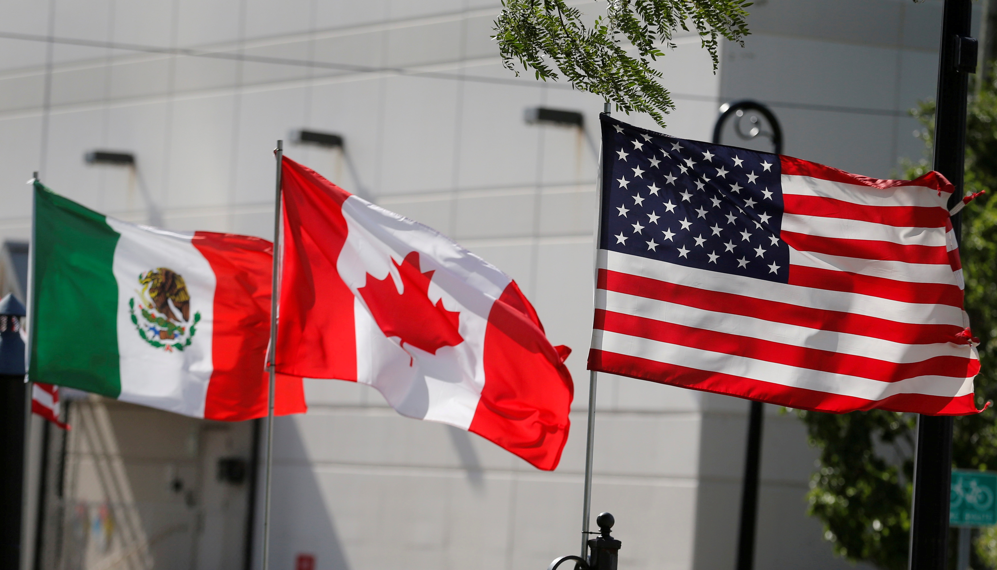 Flags of the U.S., Canada and Mexico fly next to each other in Detroit, Michigan, U.S. August 29, 2018. REUTERS/Rebecca Cook/File Photo