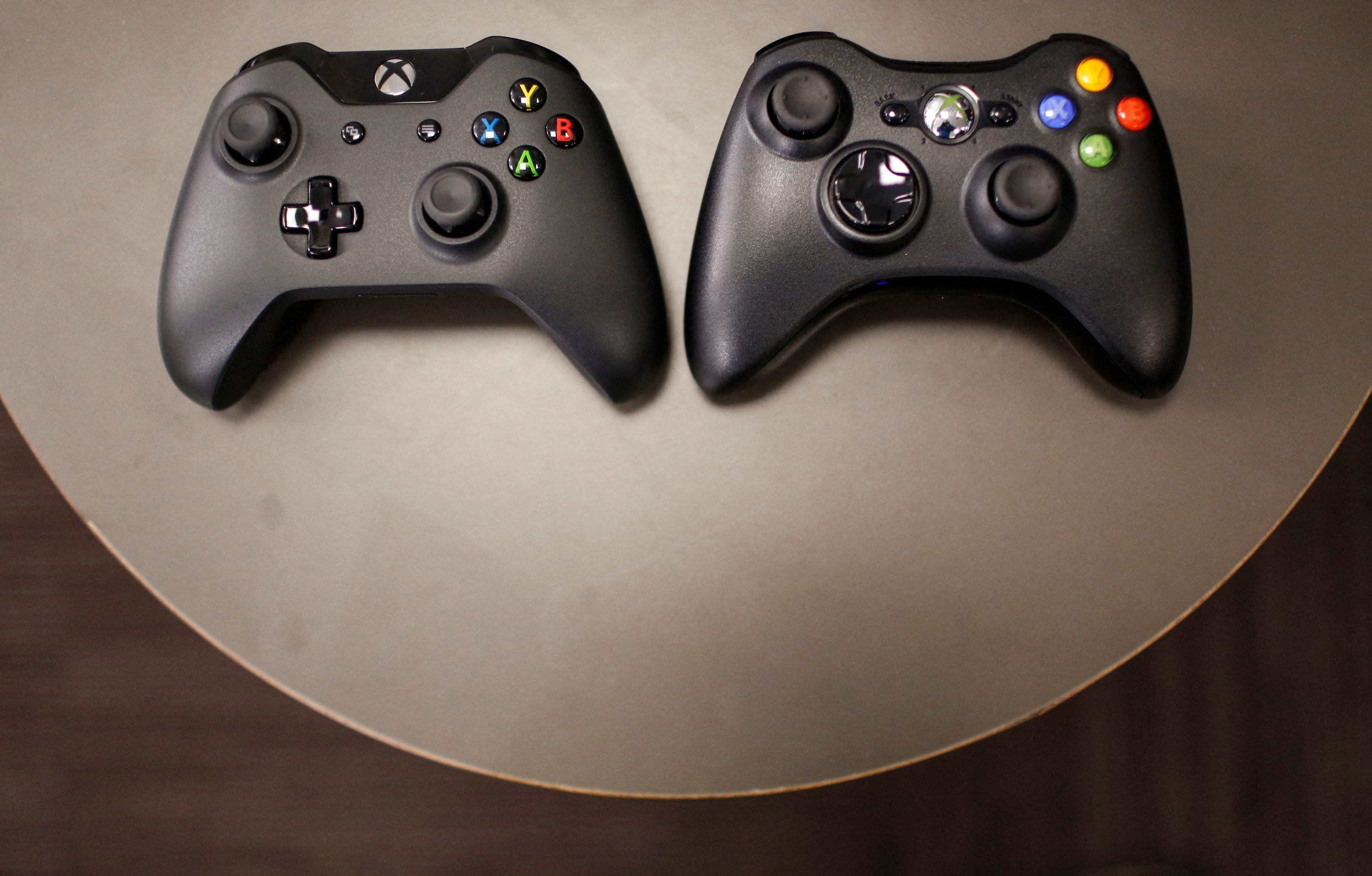The new Xbox One controller (R), next to the previous controller during a press event unveiling Microsoft's new Xbox One in Redmond, Washington May 21, 2013.  REUTERS/Nick Adams