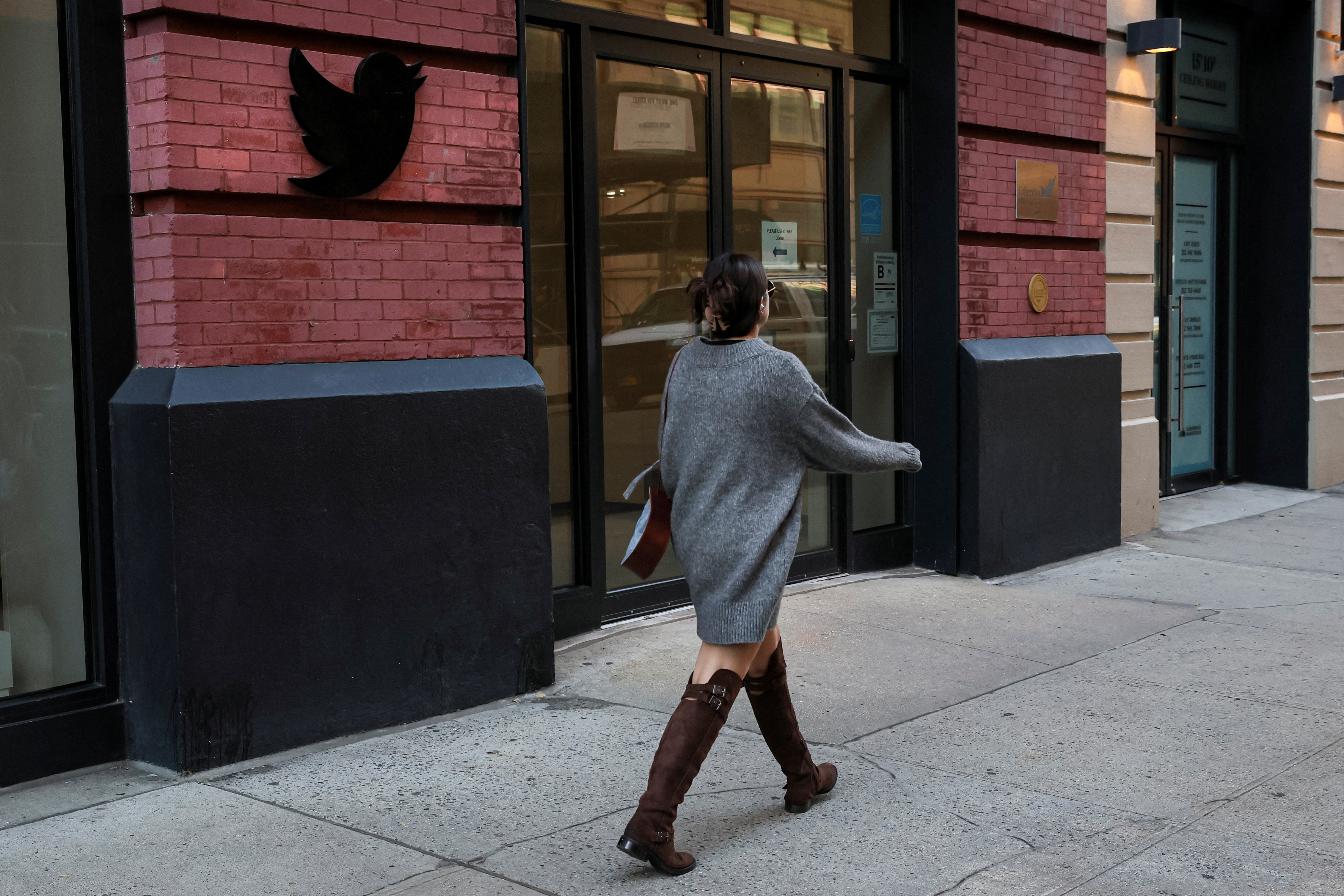A woman walks past the Twitter offices in New York