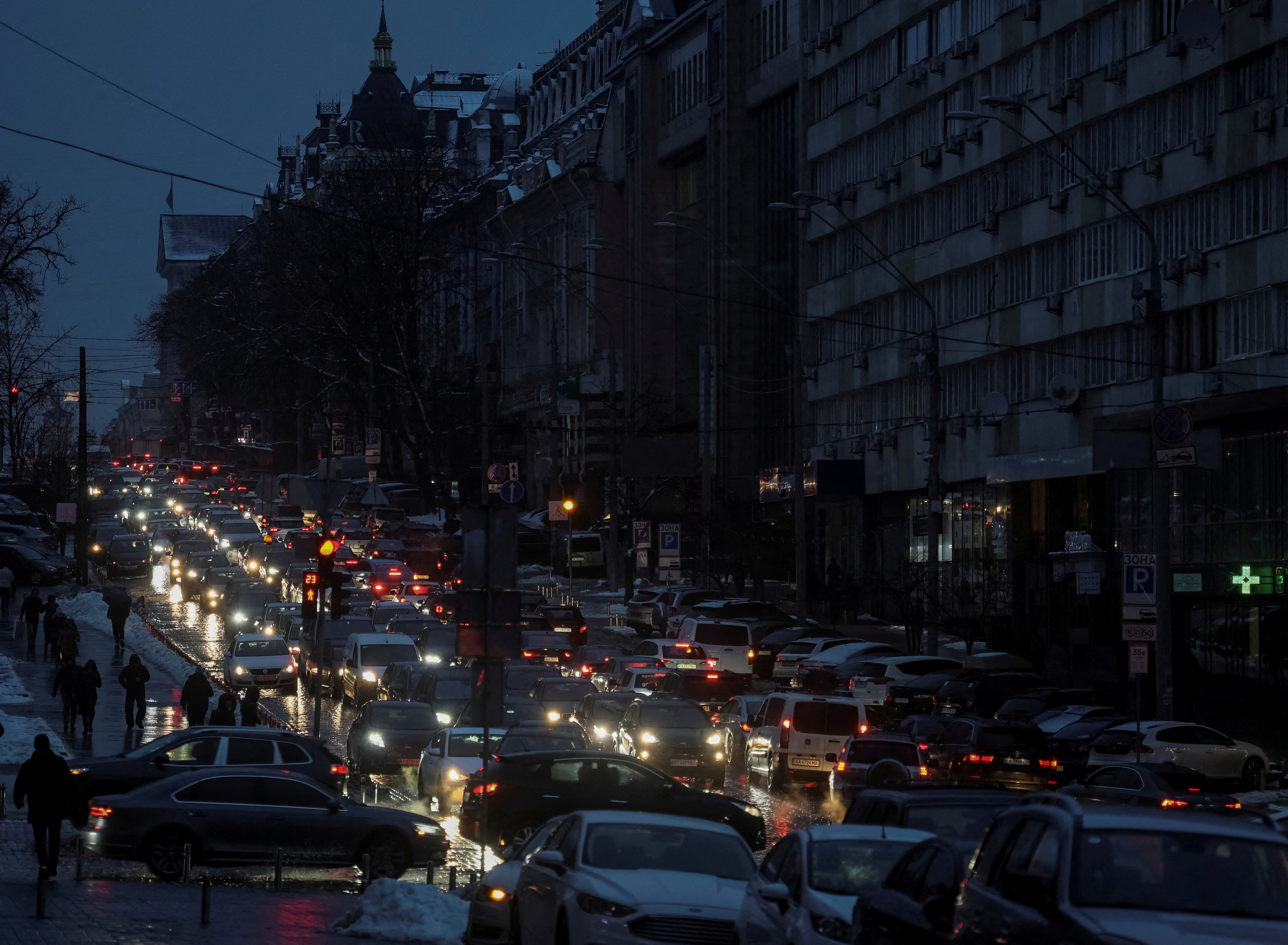 Cars are seen at a street during a power outage after critical civilian infrastructure was hit by Russian missile strikes in Kiev