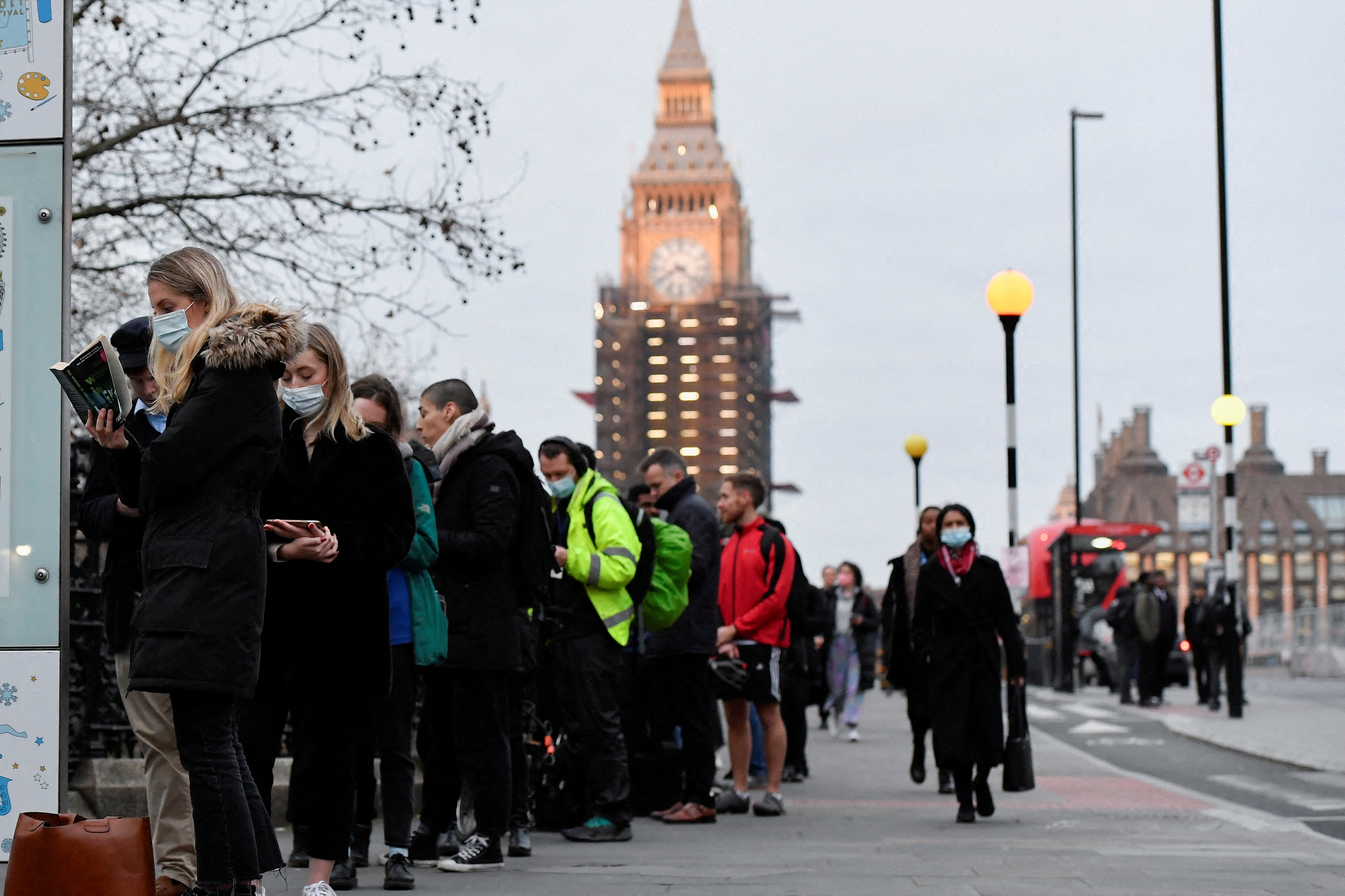 People queue at Westminster Bridge to receive COVID-19 vaccine and booster doses, as the spread of the coronavirus disease (COVID-19) continues, at a walk-in vaccination centre at Saint Thomas' Hospital in London, Britain, December 14, 2021. REUTERS/Toby Melville