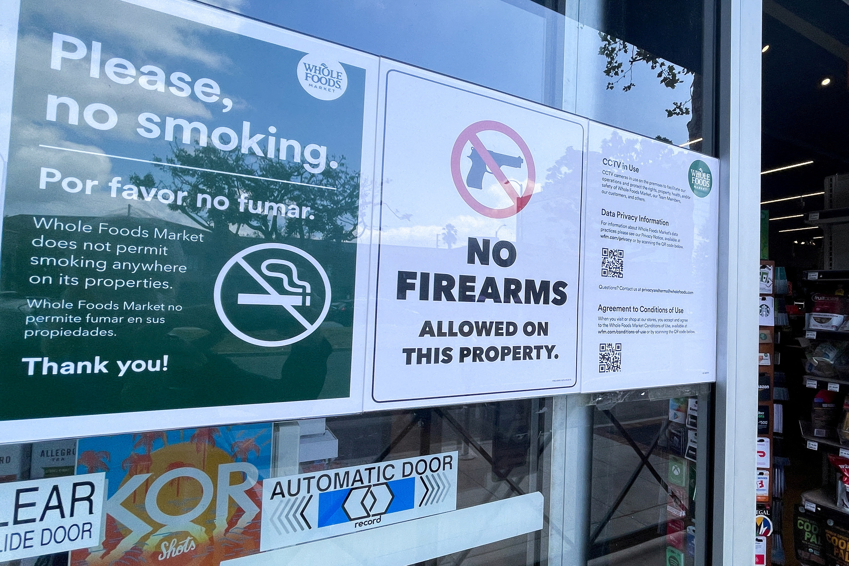 A sign forbidding customers to bring guns into supermarket is seen in Los Angeles