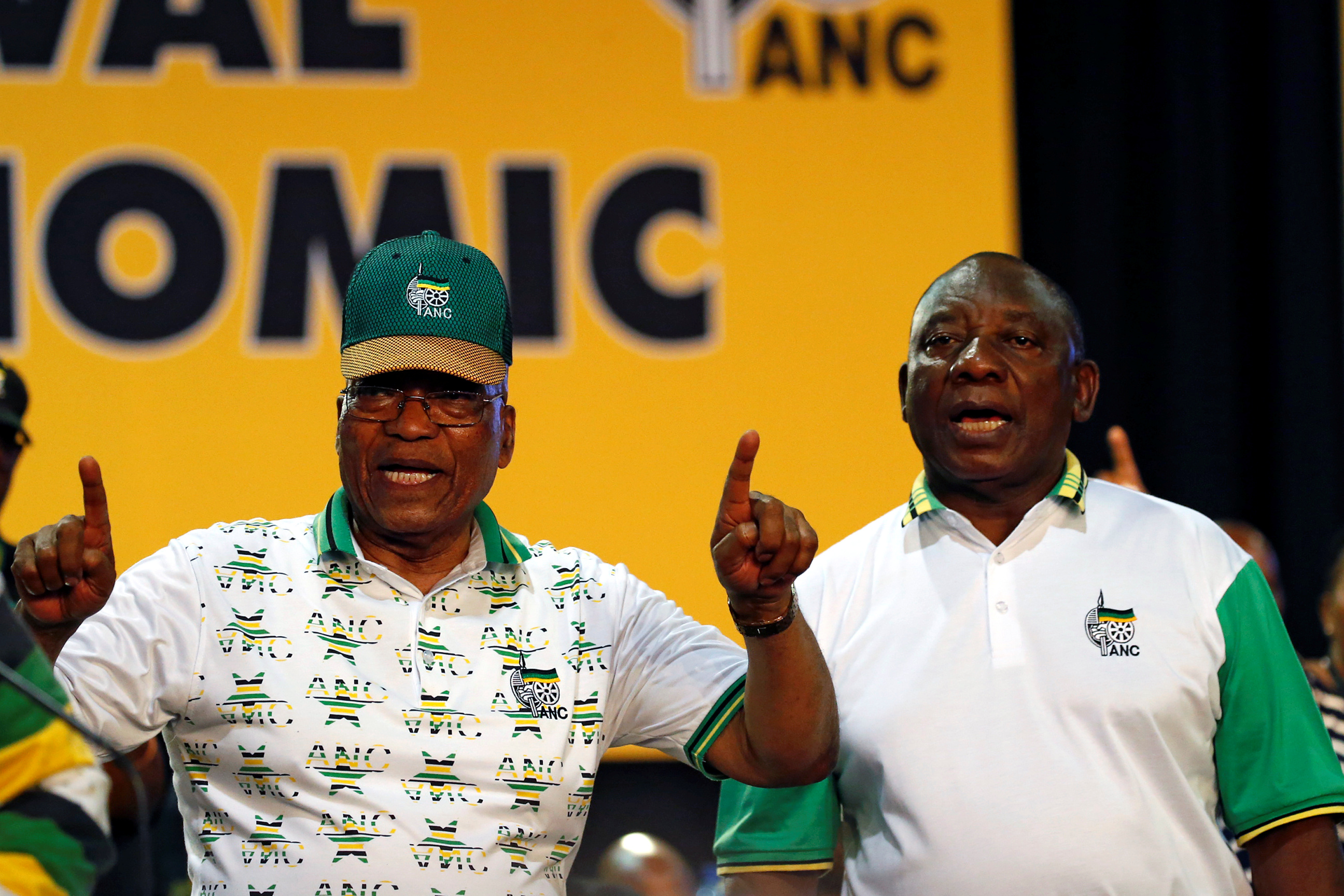 South Africa's President Jacob Zuma sings next to newly elected president of the ANC Cyril Ramaphosa during the 54th National Conference of the ruling African National Congress (ANC) at the Nasrec Expo Centre in Johannesburg