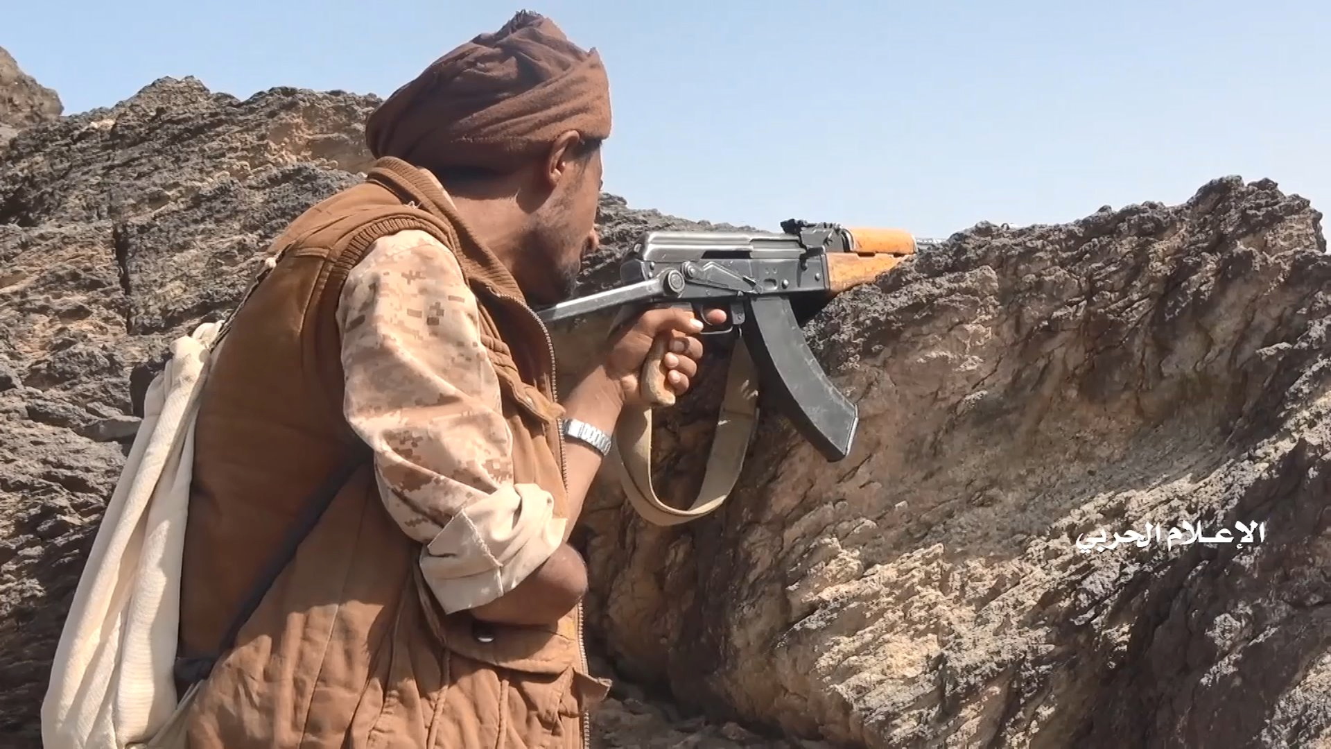 A Houthi fighter with an amputated right arm takes position at a frontline in al-Jubah district of Yemen's Marib province in a frame grab from video handed out by the Houthi's media center November 2, 2021. Houthi Media Center/Handout via Reuters/Files