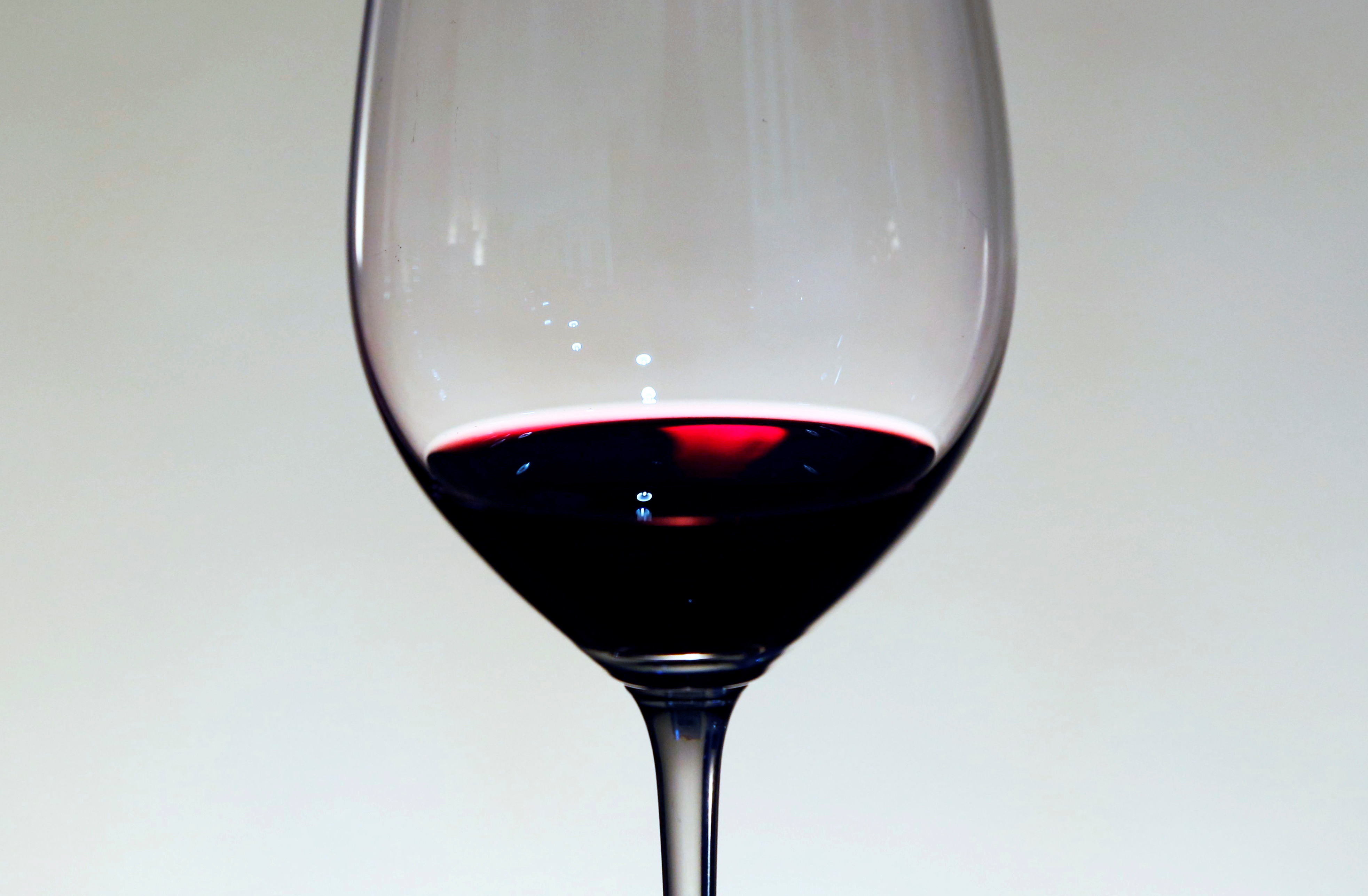 A glass of red wine is displayed at the Chateau La Louviere in Leognan