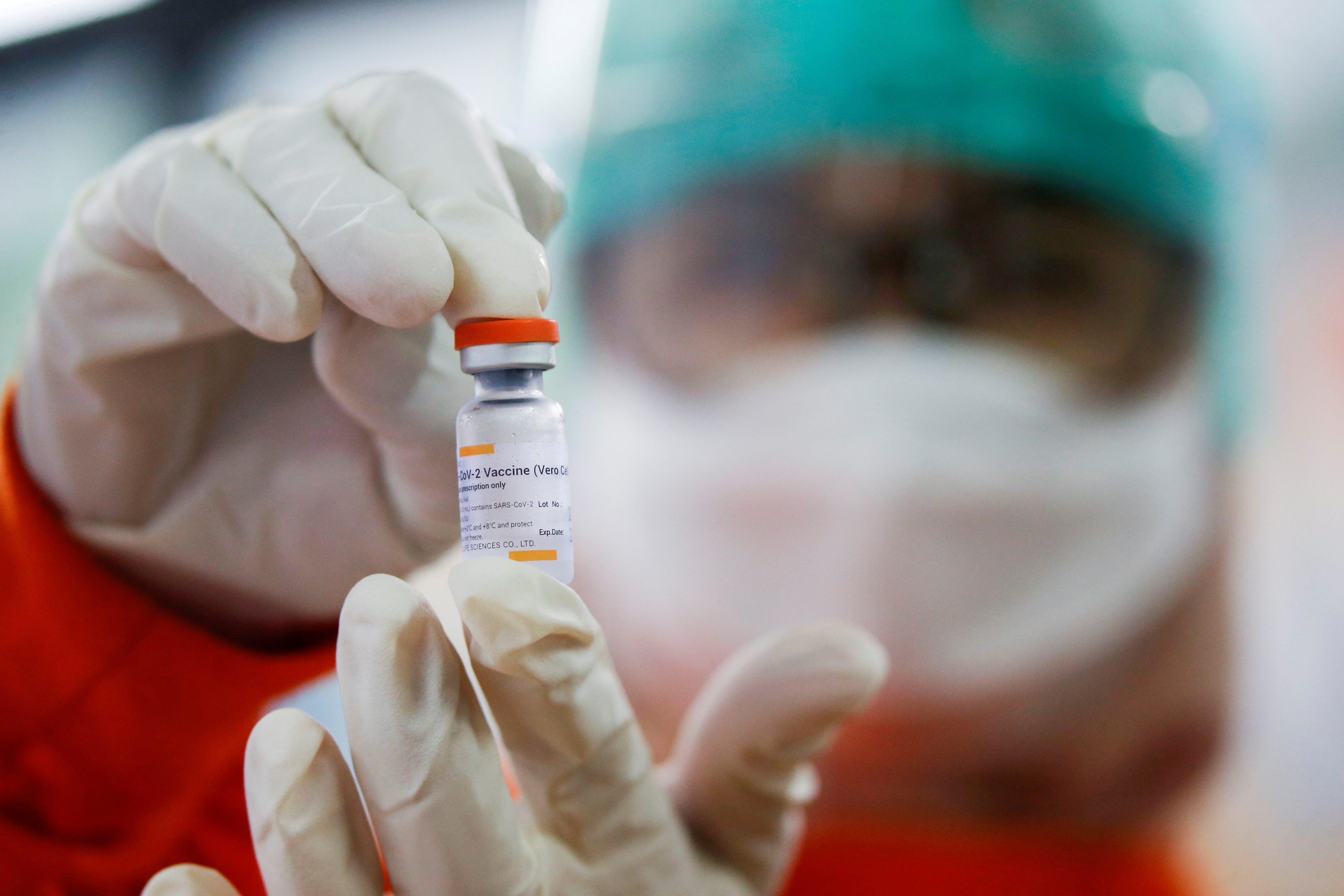 A medical worker holds a dose of the Sinovac vaccine at a district health facility as Indonesia begins mass vaccination for the coronavirus disease (COVID-19), in Jakarta